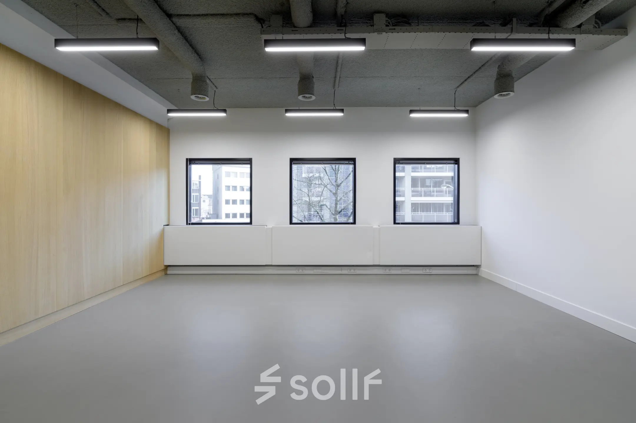 Spacious office to rent in Eindhoven Center with large windows and modern lighting, ideal for office space rental.