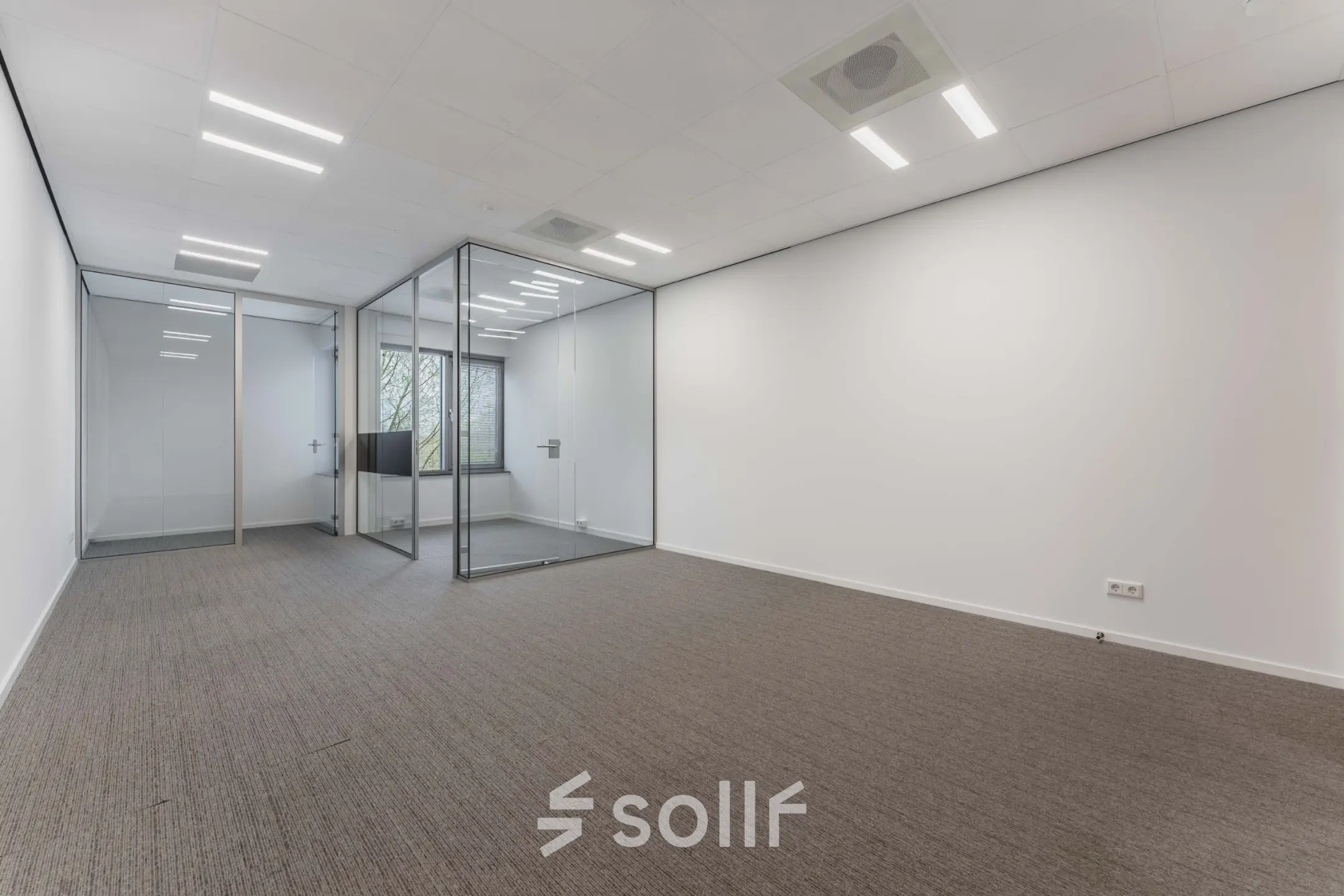 Empty office space with glass partition and neutral tones at Hurksestraat 60, ideal for office space rental in Eindhoven De Hurk.