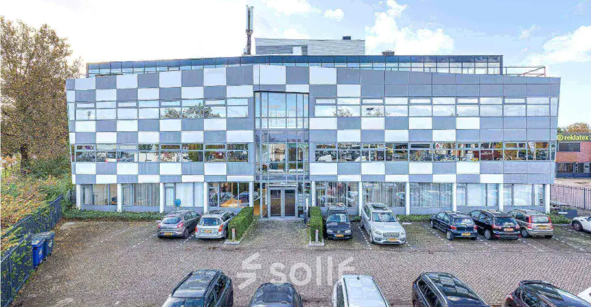 Exterior view of a modern office building at Meerenakkerplein 1-10, Eindhoven De Hurk, with parking spaces available for office space rental.