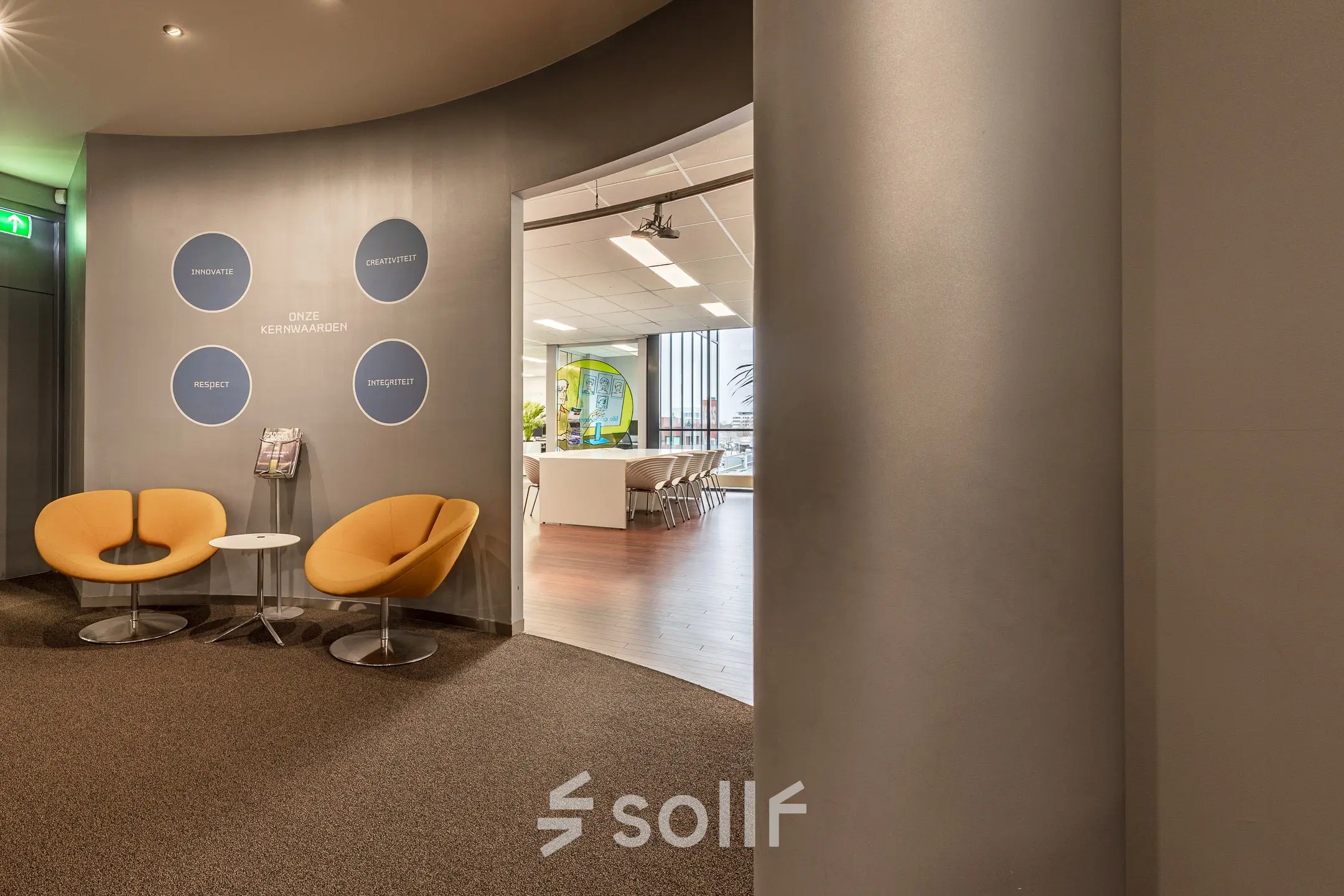 Modern office interior at Meerenakkerplein 11-20, Eindhoven De Hurk with stylish seating and visible meeting room, ideal for rent office space.