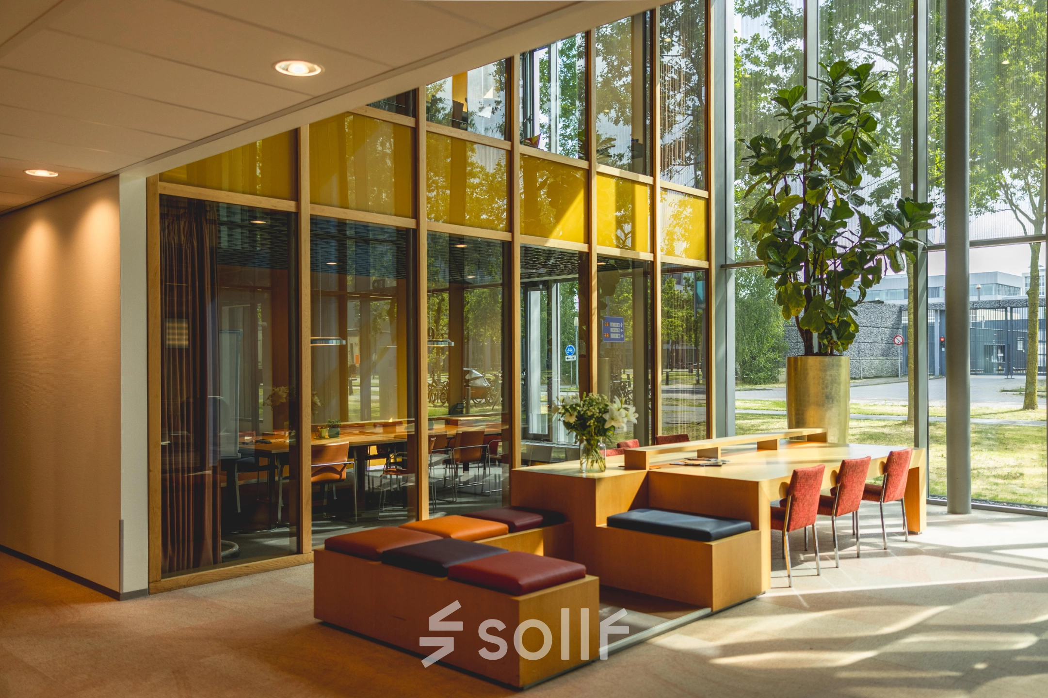 Bright, modern office space with large windows at High Tech Campus 9, Eindhoven. Stylish seating and natural light enhance the workspace. Ideal for companies seeking office space rental in a vibrant tech environment.