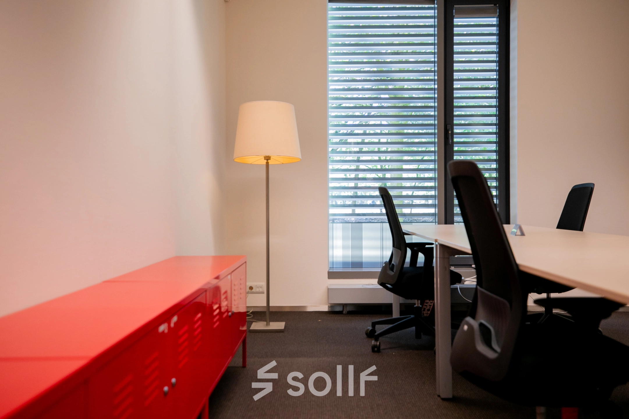 Bright office space at High Tech Campus 9, Eindhoven, featuring modern desks, ergonomic chairs, and a stylish floor lamp, ideal for productive workdays.