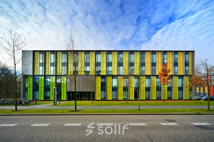 Colorful exterior of an office building located at High Tech Campus 9, Eindhoven, featuring a modern facade with vertical color panels. Ideal for office space rental in a vibrant tech environment.