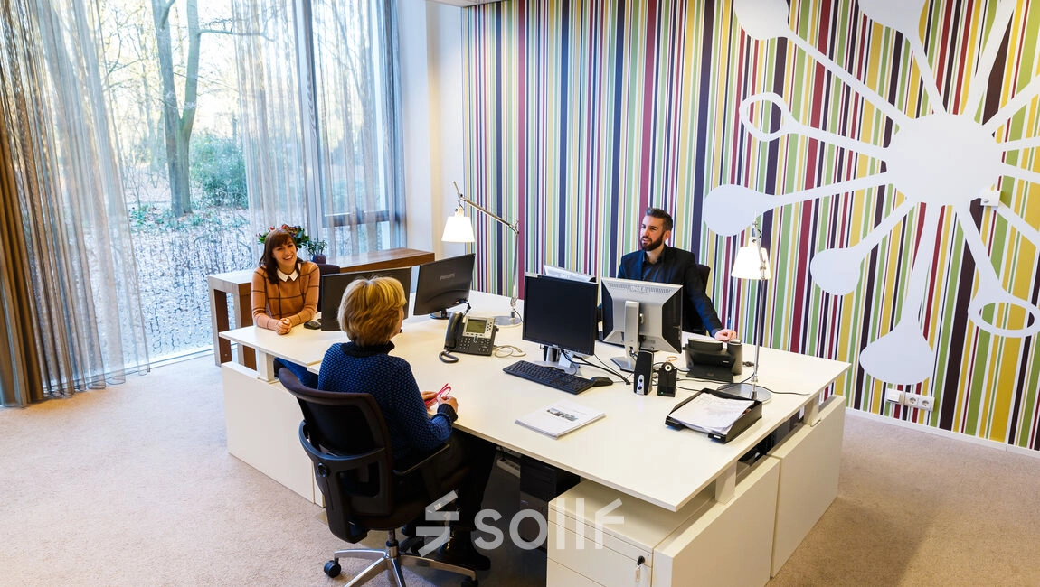 Modern office space at TU Campus, De Lismortel 31, Eindhoven High Tech Campus; features a bright workspace with colorful wall accents, furnished with desks and computers, suitable for office space rental.