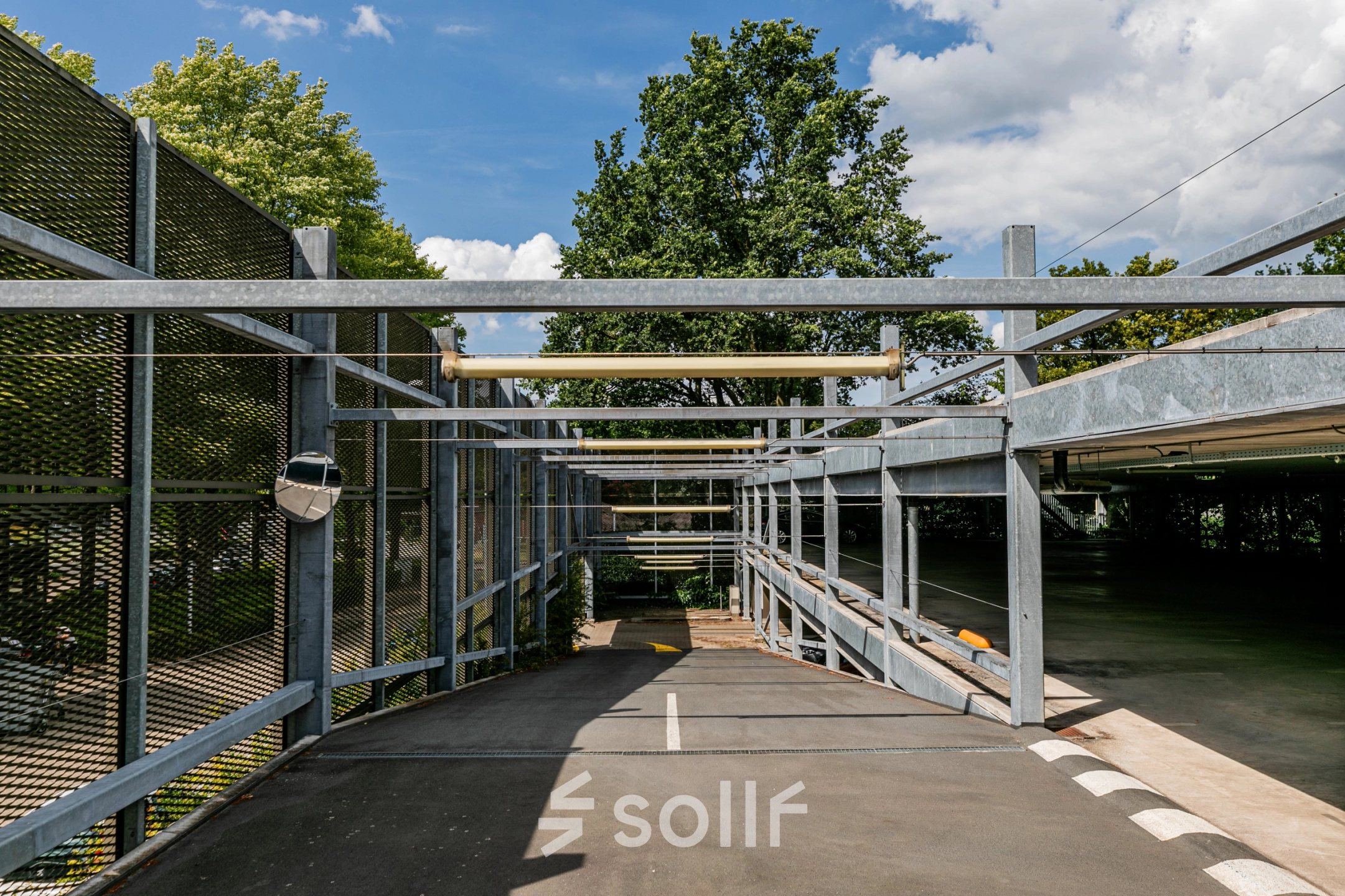 Exterior view of the parking area at TU Campus, De Lismortel 31, Eindhoven High Tech Campus, highlighting the open structure and greenery.