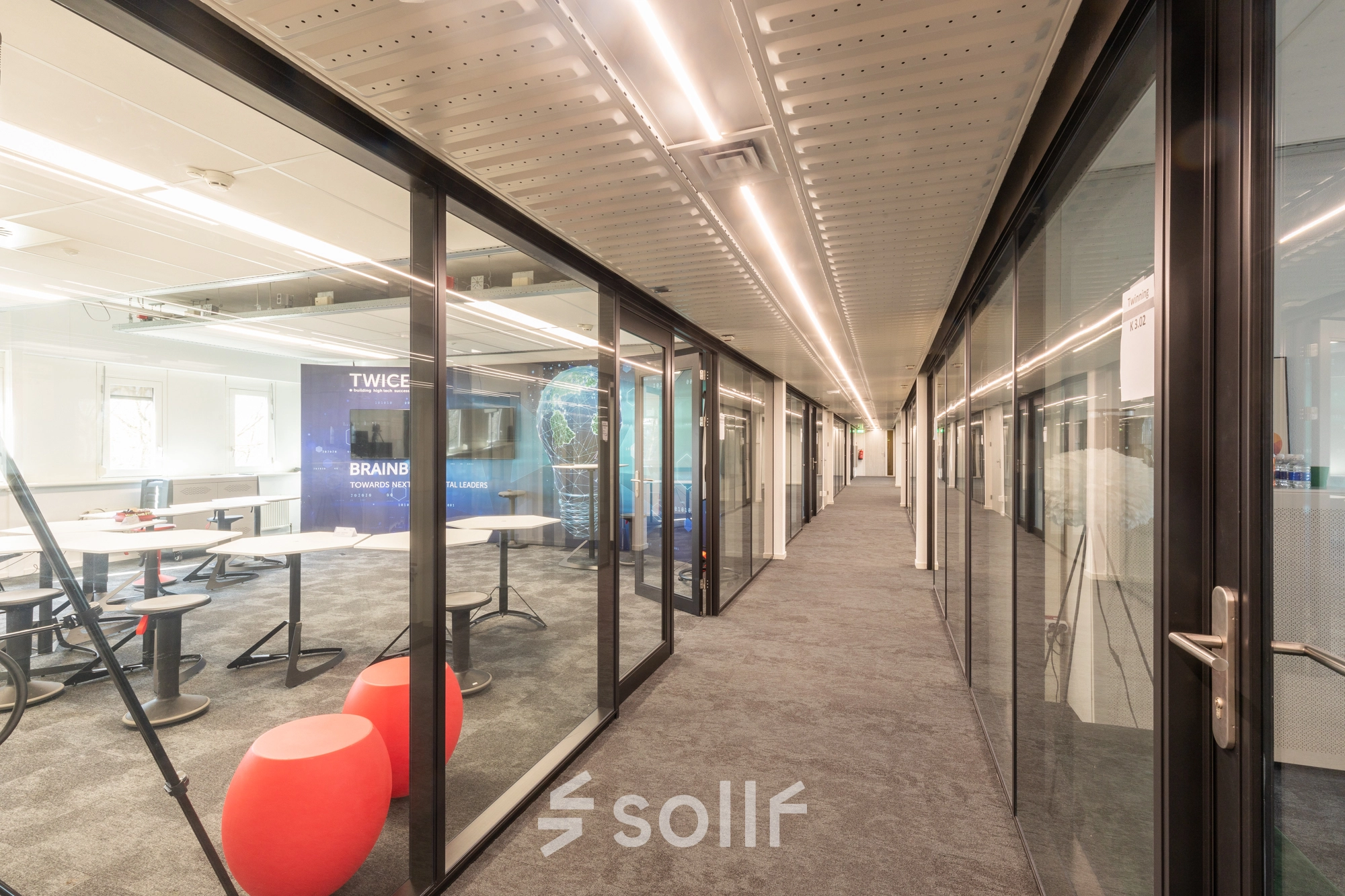 Modern interior workspace featuring glass walls and creative seating at TU Campus, De Zaale 11 in Eindhoven High Tech Campus, ideal for office space rental.
