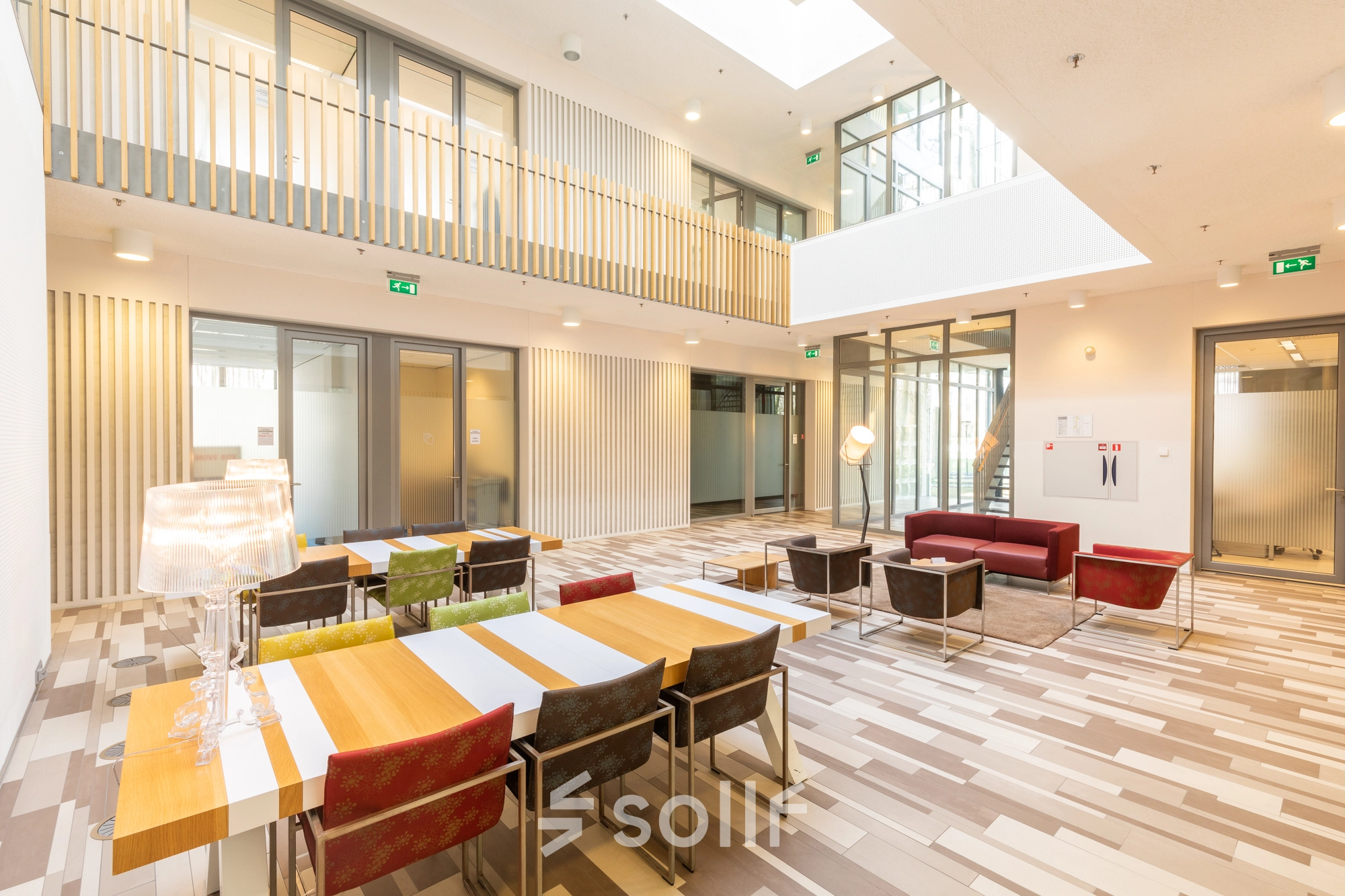 Bright office space with tables and chairs in a modern design, perfect for rent office space at TU campus Eindhoven High Tech Campus.