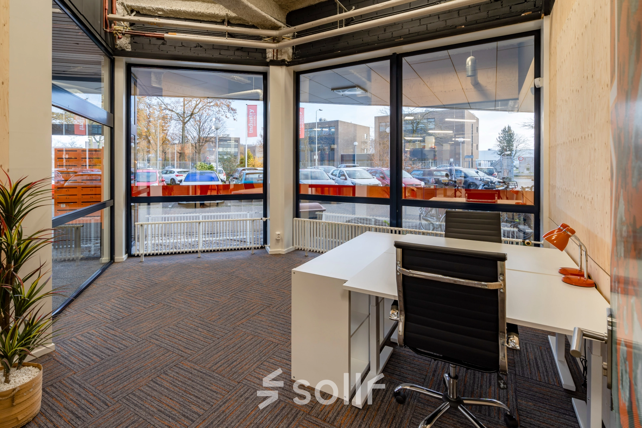 Bright, furnished office space at Tarasconweg 2, Eindhoven North, featuring large windows and a modern desk setup, ideal for your next office space rental.