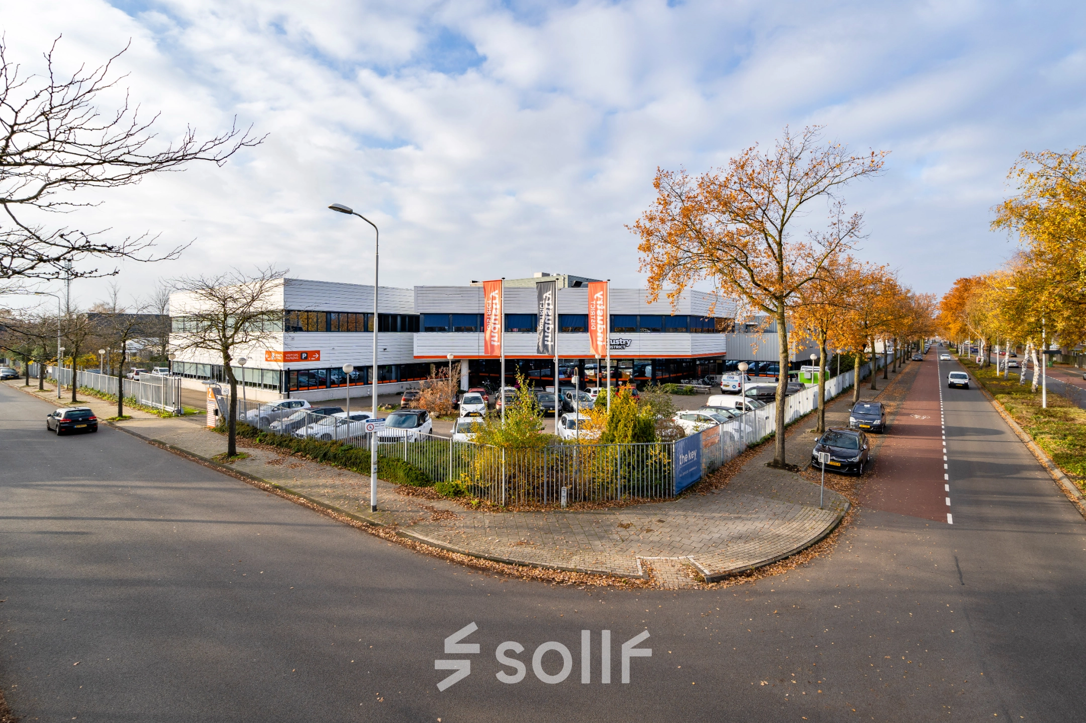 Exterior view of an office building at Tarasconweg 2, Eindhoven North, featuring ample parking space and a modern design. Ideal for those seeking office space rental in a convenient location.
