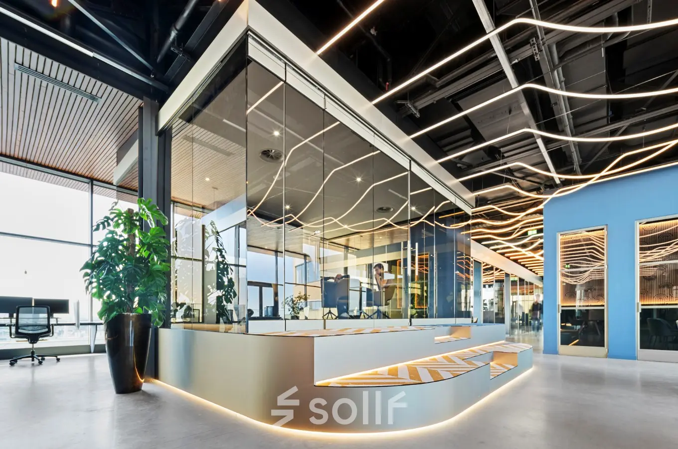 Modern office to rent at Achtseweg Zuid 159R, Eindhoven Strijp-S, featuring sleek design with contemporary glass partitioning and unique lighting. Ideal for office space rental.