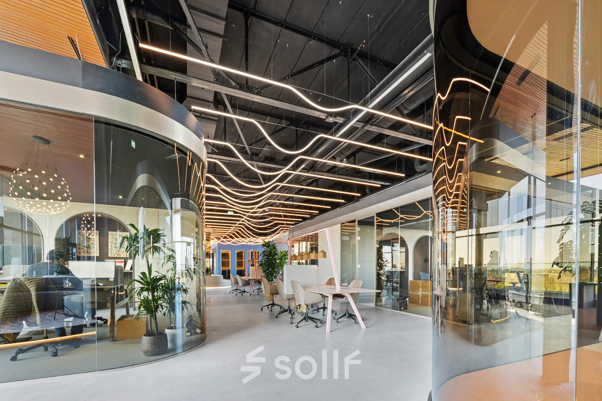 Contemporary office space with sleek glass partitions, stylish lighting, and modern furnishings, available for rent at Achtseweg Zuid 159R, Eindhoven Strijp-S.