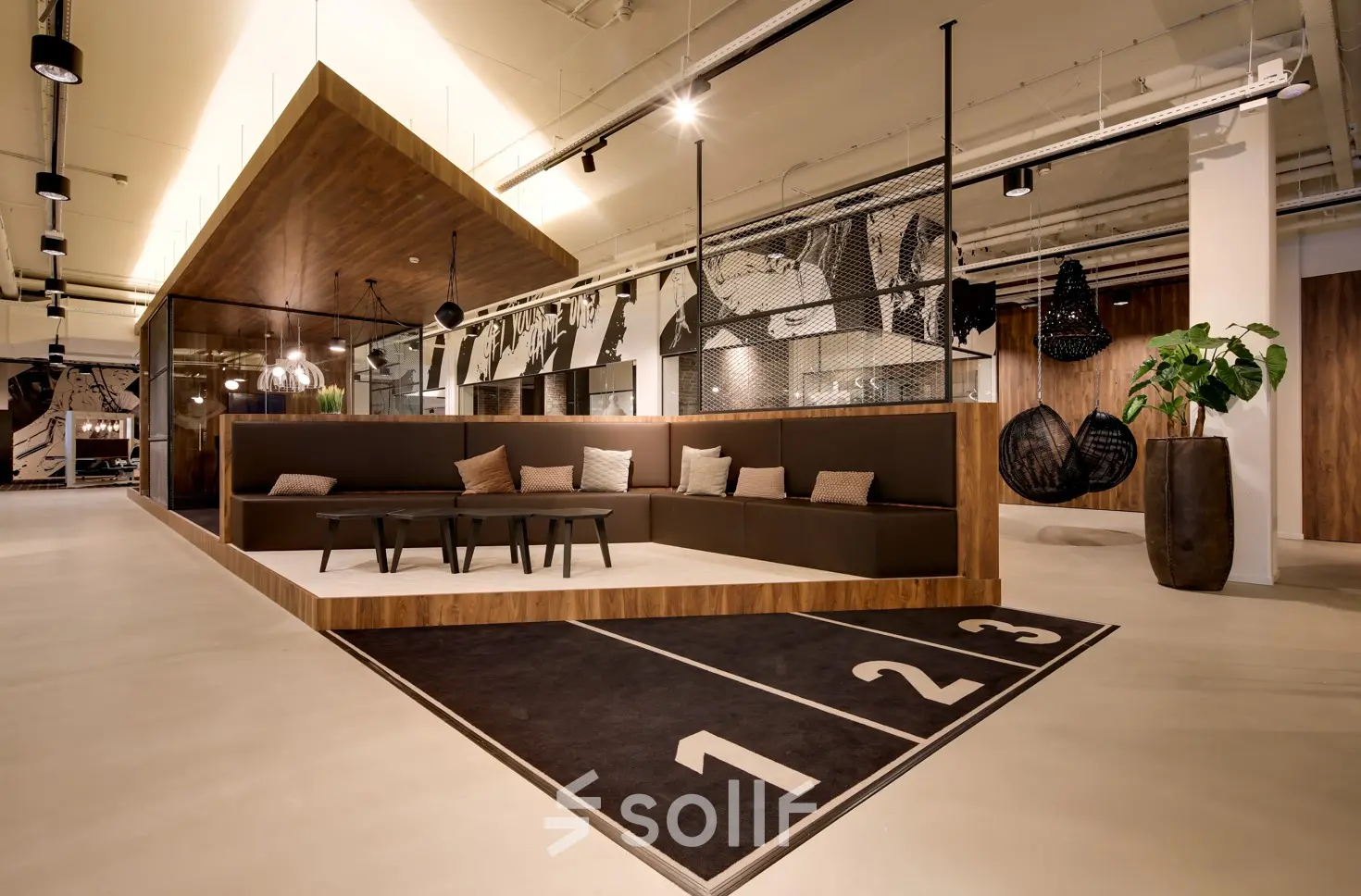 Modern office to rent at Frederiklaan 10E, Eindhoven Strijp-S, featuring a stylish seating area with contemporary furnishings and artistic decor. Ideal for office space rental in a vibrant setting.