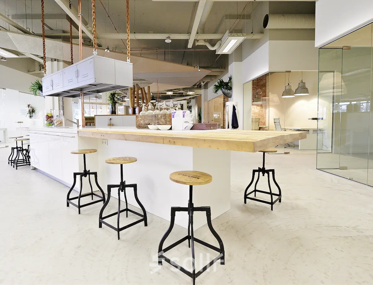 Modern office in Eindhoven Strijp-S with contemporary furnishings and open layout, ideal for office space rental. Sleek design and ample seating make this a perfect office to rent.