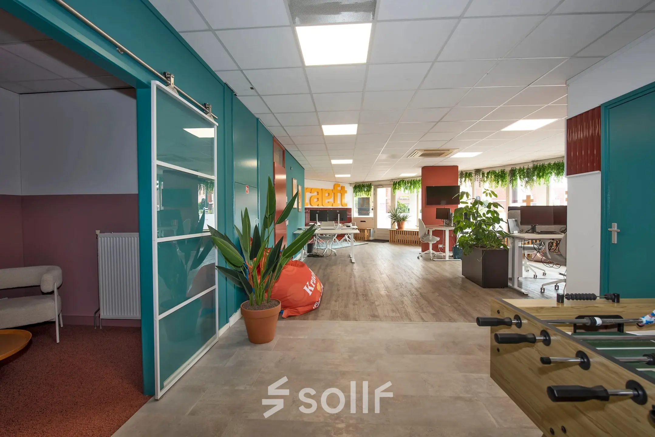 Spacious office to rent at Boddenkampsingel 95, Enschede, featuring modern workspaces with vibrant decor and greenery. Ideal for office space rental.