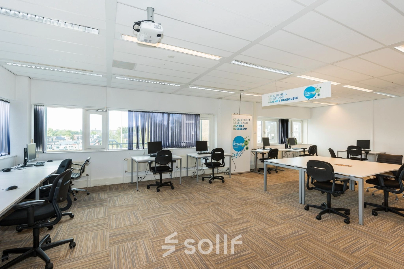 Bright and spacious office interior at Brandweerstraat 20-30, Enschede, featuring modern workstations with ample natural light, ergonomic chairs, and a clean layout ideal for productive work. Perfect office space rental opportunity.
