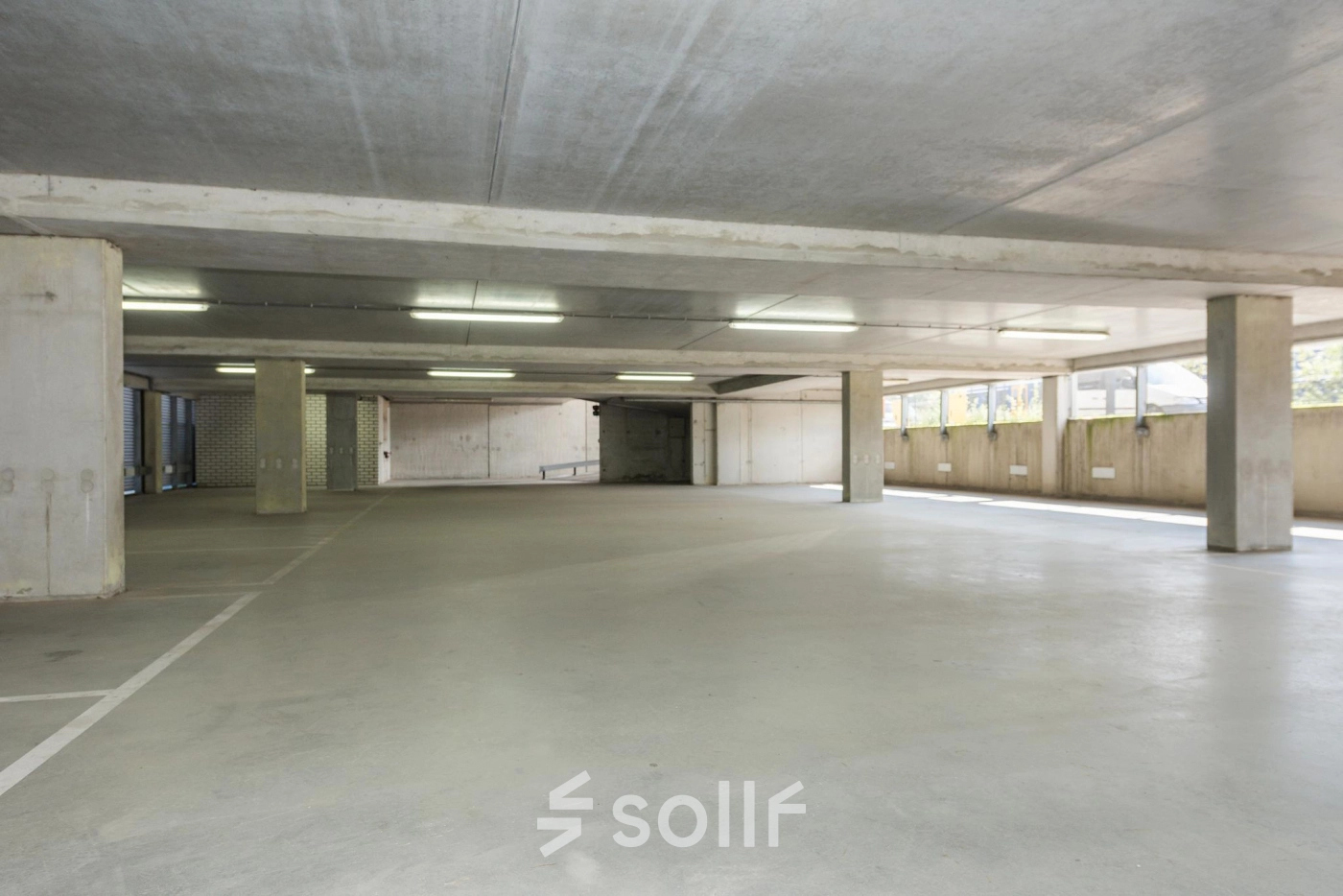 Spacious, well-lit parking area at Brandweerstraat 20-30 in Enschede, suitable for tenants seeking convenient office space rental with ample parking facilities on-site.