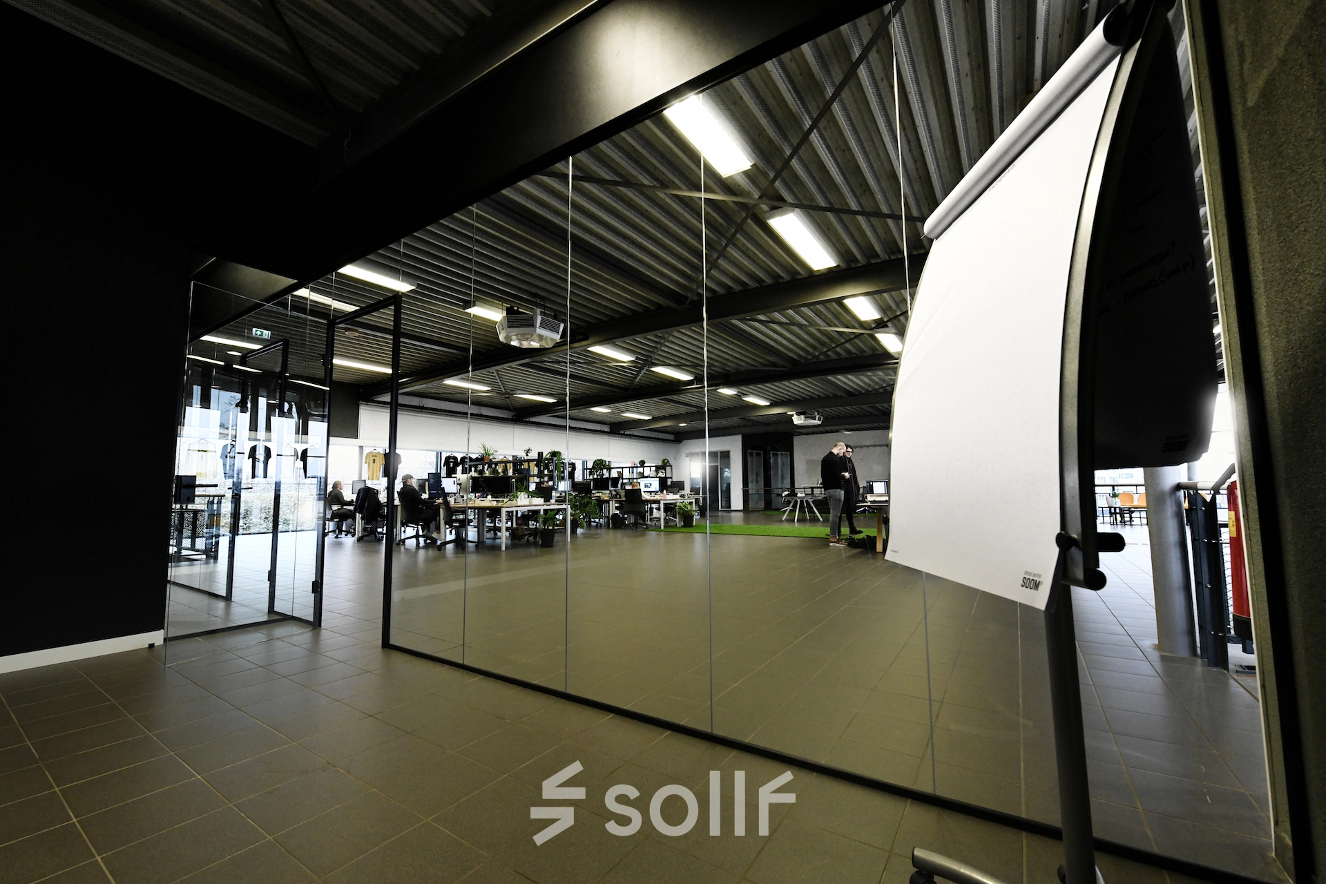 Spacious office to rent at Parkweg 102, Enschede featuring modern desks, sleek glass partitions, and collaborative workstations. Ideal for businesses seeking office space rental.