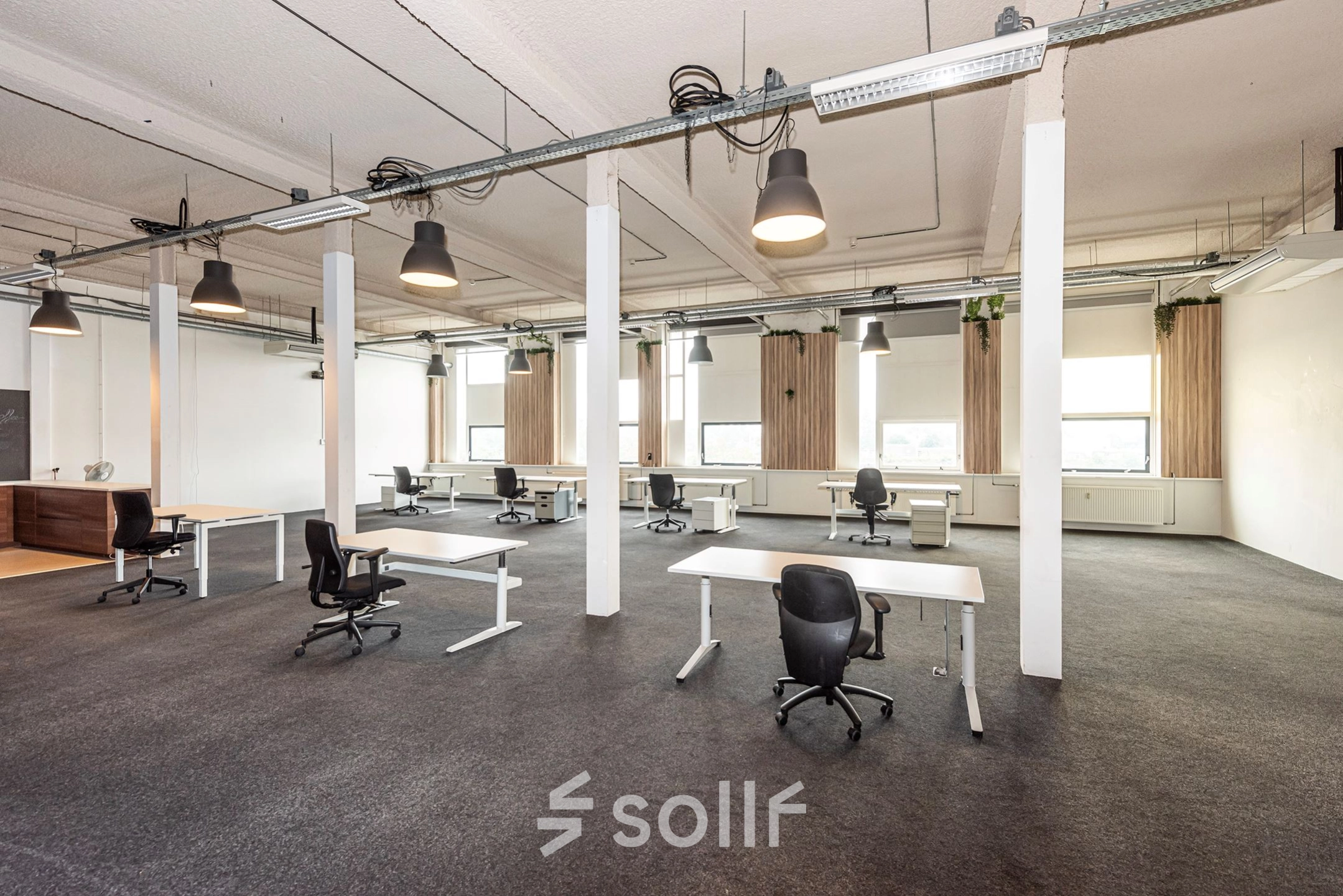 Furnished office space for rent at Rigtersbleek-Zandvoort 10, Enschede, featuring multiple desks and chairs in an open-plan layout.