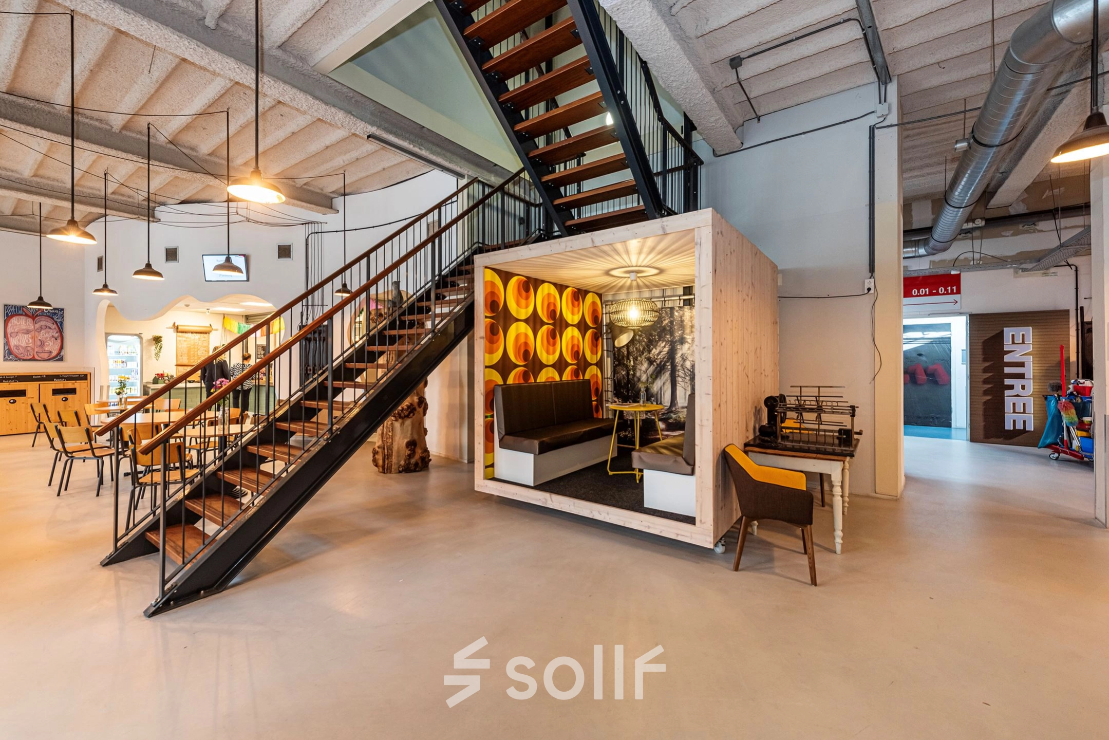 Modern office space at Rigtersbleek-Zandvoort 10, Enschede featuring a stylish meeting area under a staircase, ideal for rent office space options.