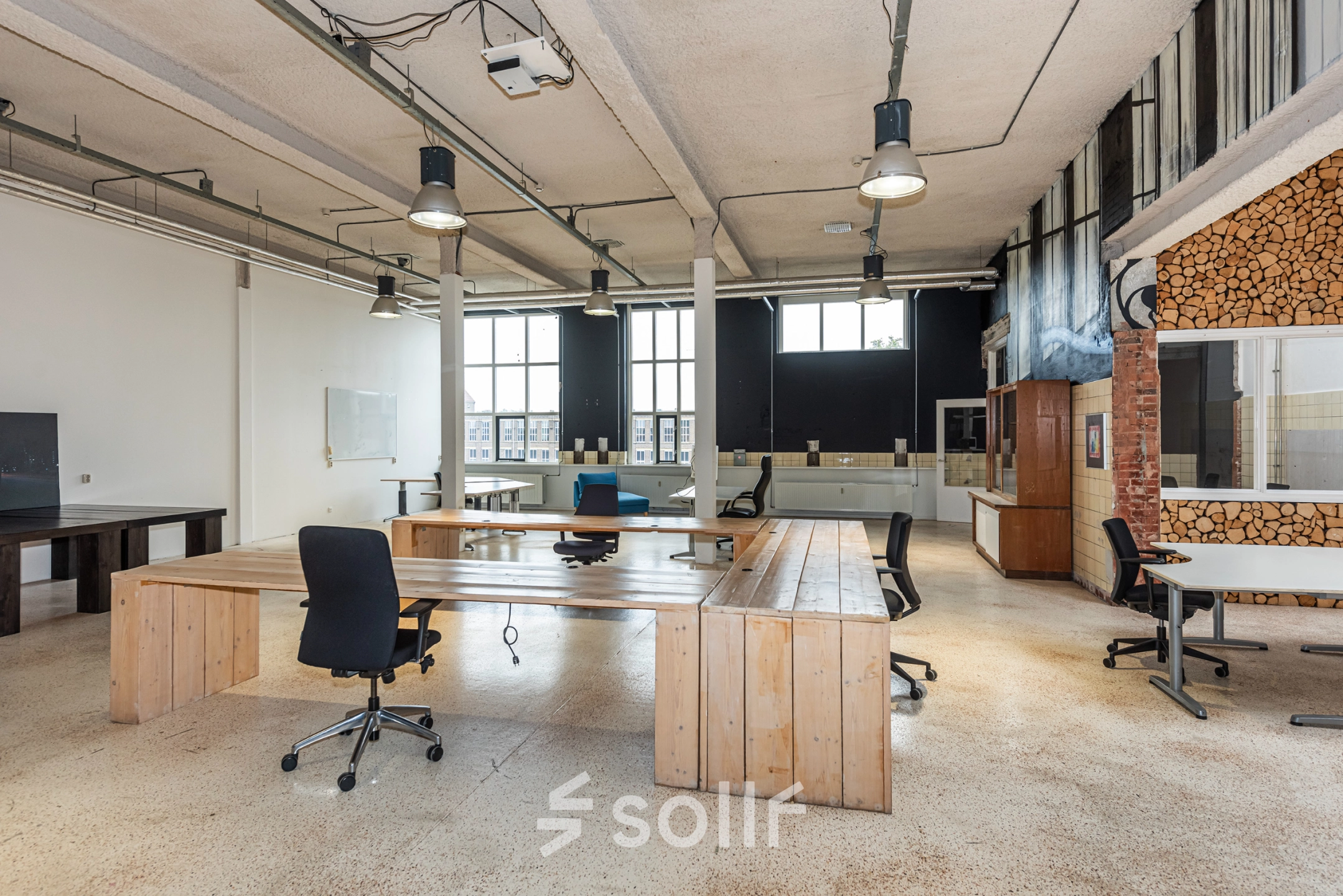 Spacious office in Enschede at Rigtersbleek-Zandvoort 10 featuring wooden desks and chairs. Ideal for office space rental.