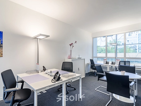 Bright office space to rent at Mergenthaler Allee 15-21, Eschborn, featuring modern furnishings and ample natural light from large windows.