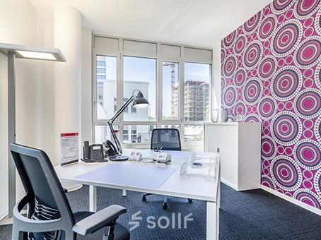 Bright office space with a desk, chair, and vibrant patterned wall, perfect for office space rental at Mergenthaler Allee 15-21, Eschborn.