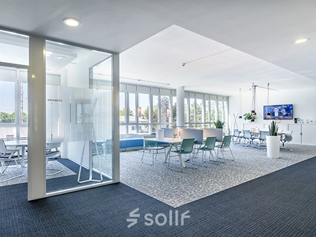 Spacious office to rent at Mergenthaler Allee 15-21, Eschborn, featuring a bright, open floorplan with modern furniture and large windows.