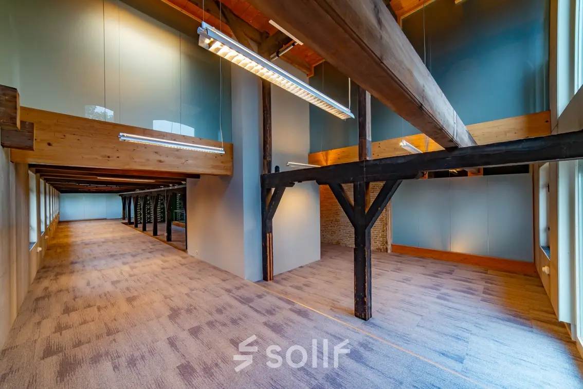 Spacious office for rent at Prins Hendrikkade 3, Franeker, featuring rustic beams and natural lighting, ideal for dynamic office space rental.