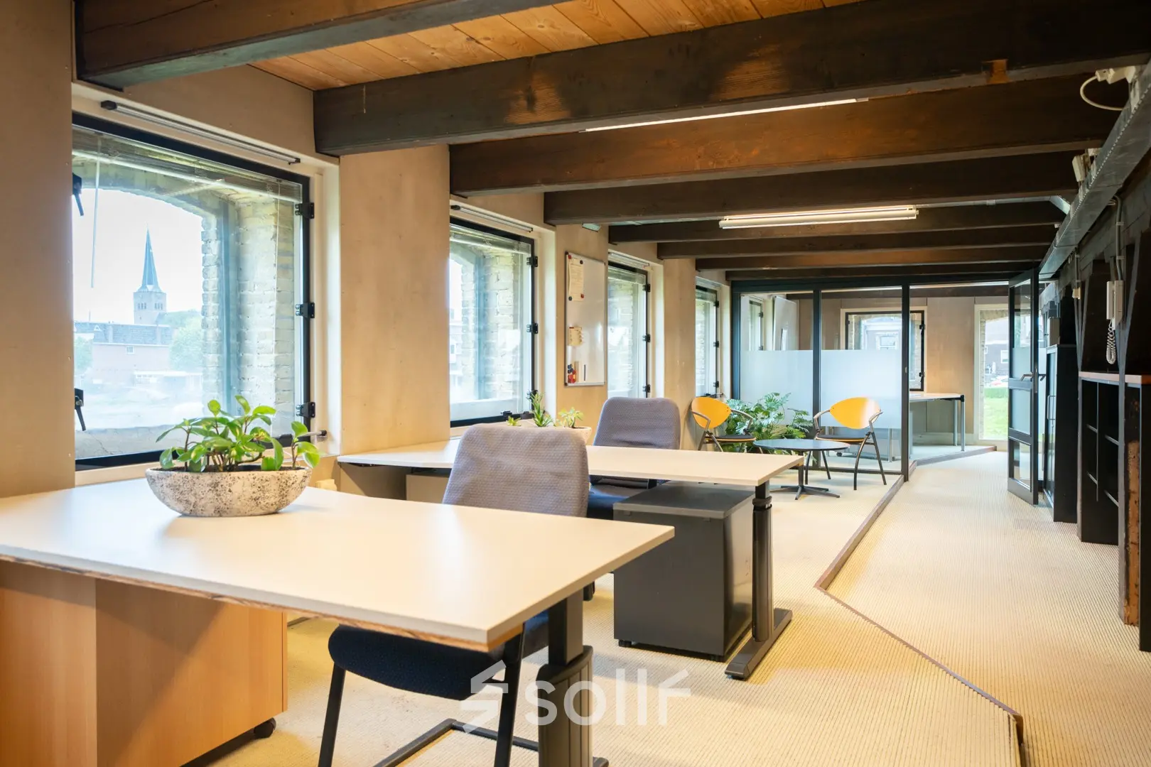 Bright office space for rent at Prins Hendrikkade 3, Franeker, with modern desks and chairs, providing a comfortable workspace with large windows and plenty of natural light.