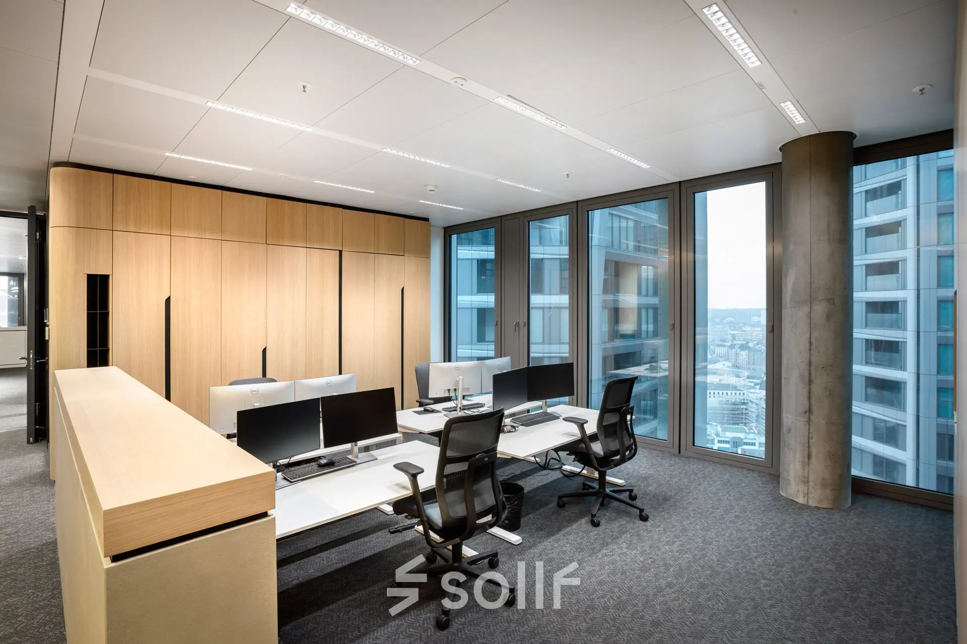 Modern office space in Junghofstraße 9, Frankfurt Center, featuring sleek workstations with large windows offering city views, ideal for office space rental.