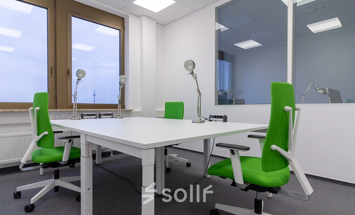 Bright office space at Eschborner Landstraße 42-50, Frankfurt West, featuring a modern setup with green chairs and desks suitable for office space rental.
