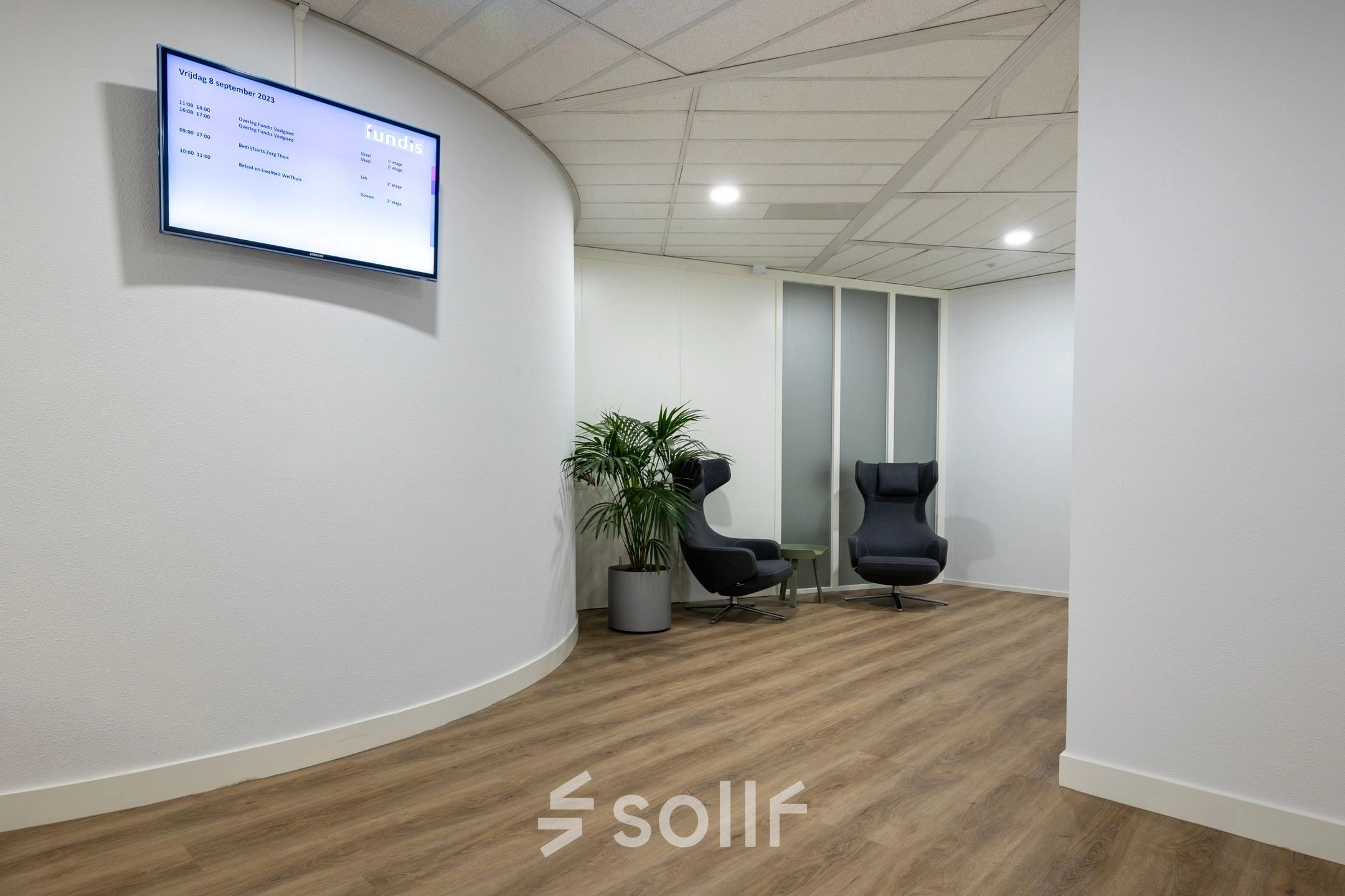 Office space at Groningenweg 8 8 in Gouda, featuring a modern reception area with comfortable seating and digital display, available for office space rental.