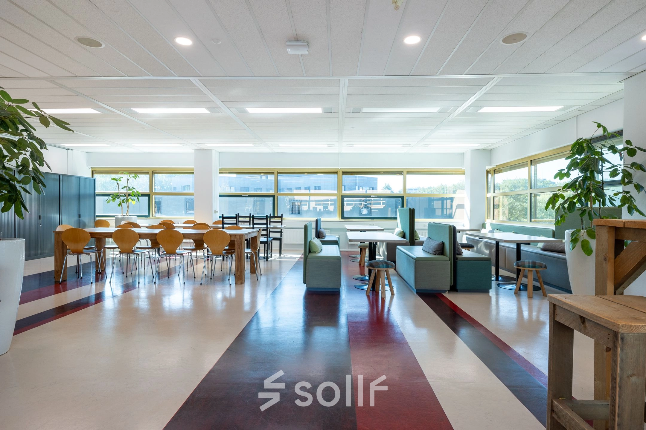 Open-plan office space at Groningenweg 8 8, Gouda, featuring a variety of seating options and natural light, ideal for office space rental.