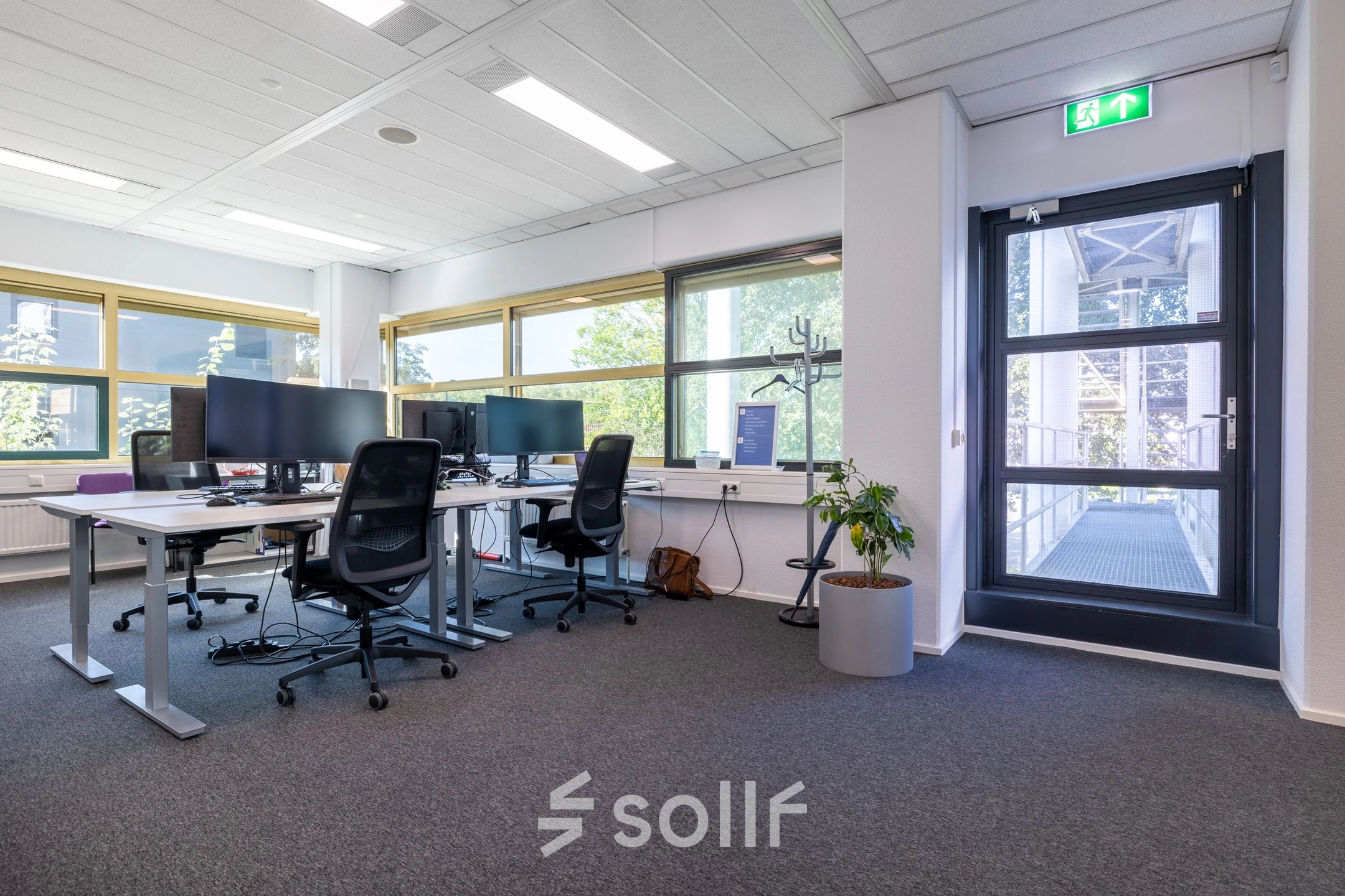 Modern office space in Gouda with desks, chairs, and large windows; ideal for office space rental.