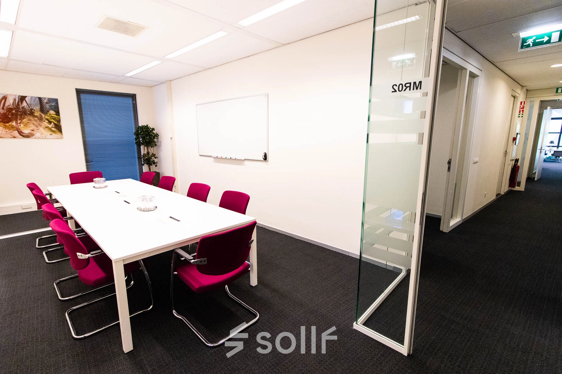 Bright office space at Kampenringweg 45, Gouda, featuring a conference table with red chairs, available for rent. Ideal for office space rental.