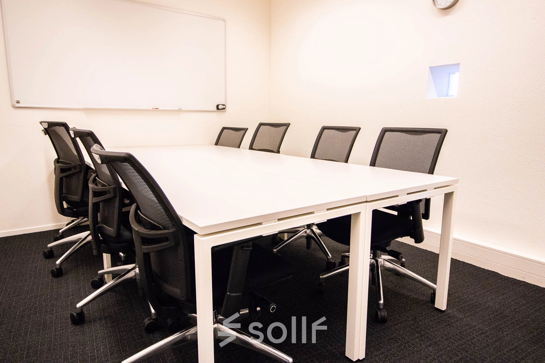 Office space rental at Kampenringweg 45, Gouda, featuring a meeting room with a large table, multiple chairs, and a whiteboard, perfect for collaborative sessions.