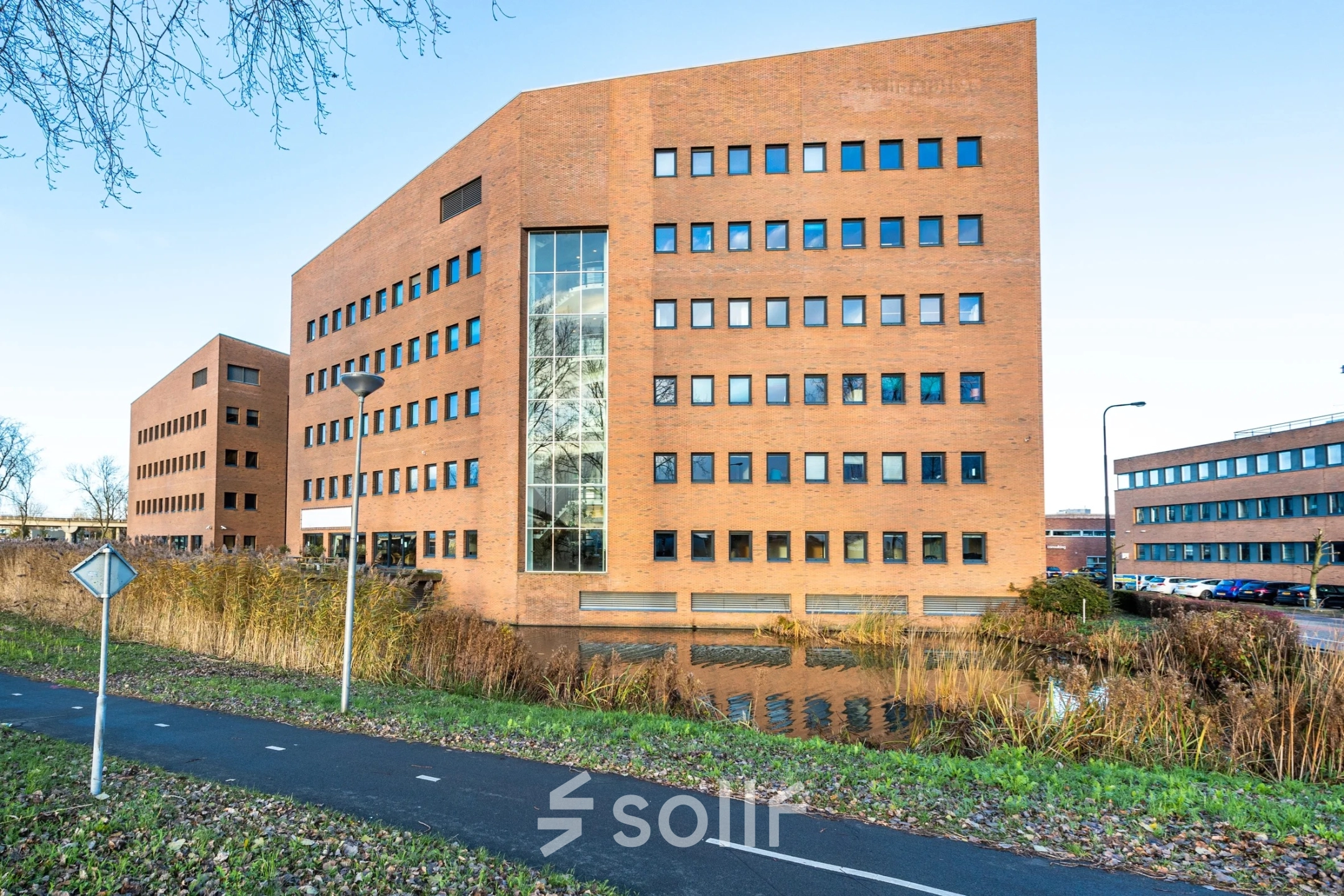 Exterior view of a brick office building at Zuidelijk Halfrond 1, Gouda, ideal for those seeking office space rental.