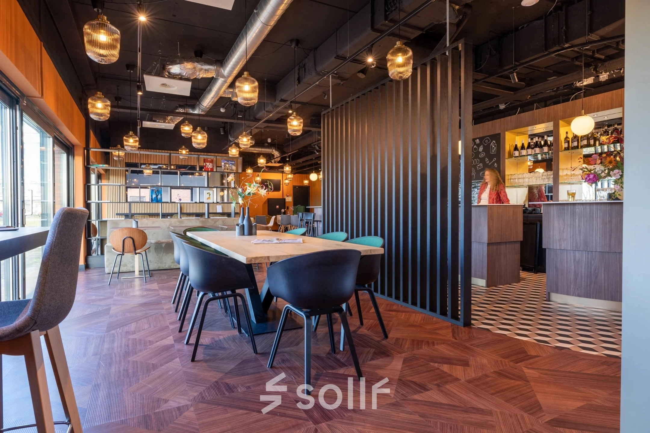 Modern furnished office space in Gouda with a stylish open floor plan featuring wooden floors and contemporary lighting. Ideal for office space rental.