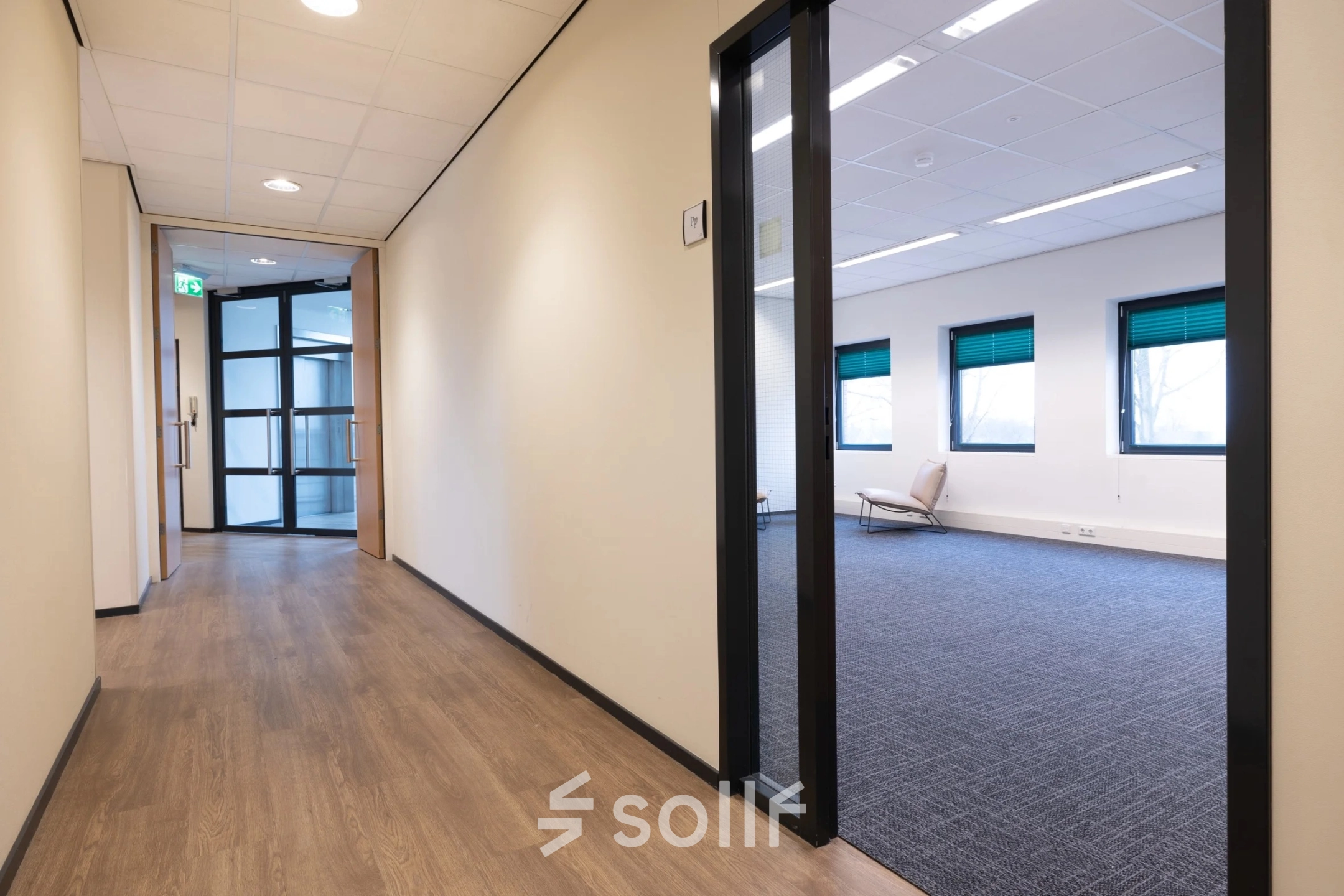 Interior view of an office space for rent at Zuidelijk Halfrond 1, Gouda. The room features large windows and minimal furnishings, suitable for office space rental.