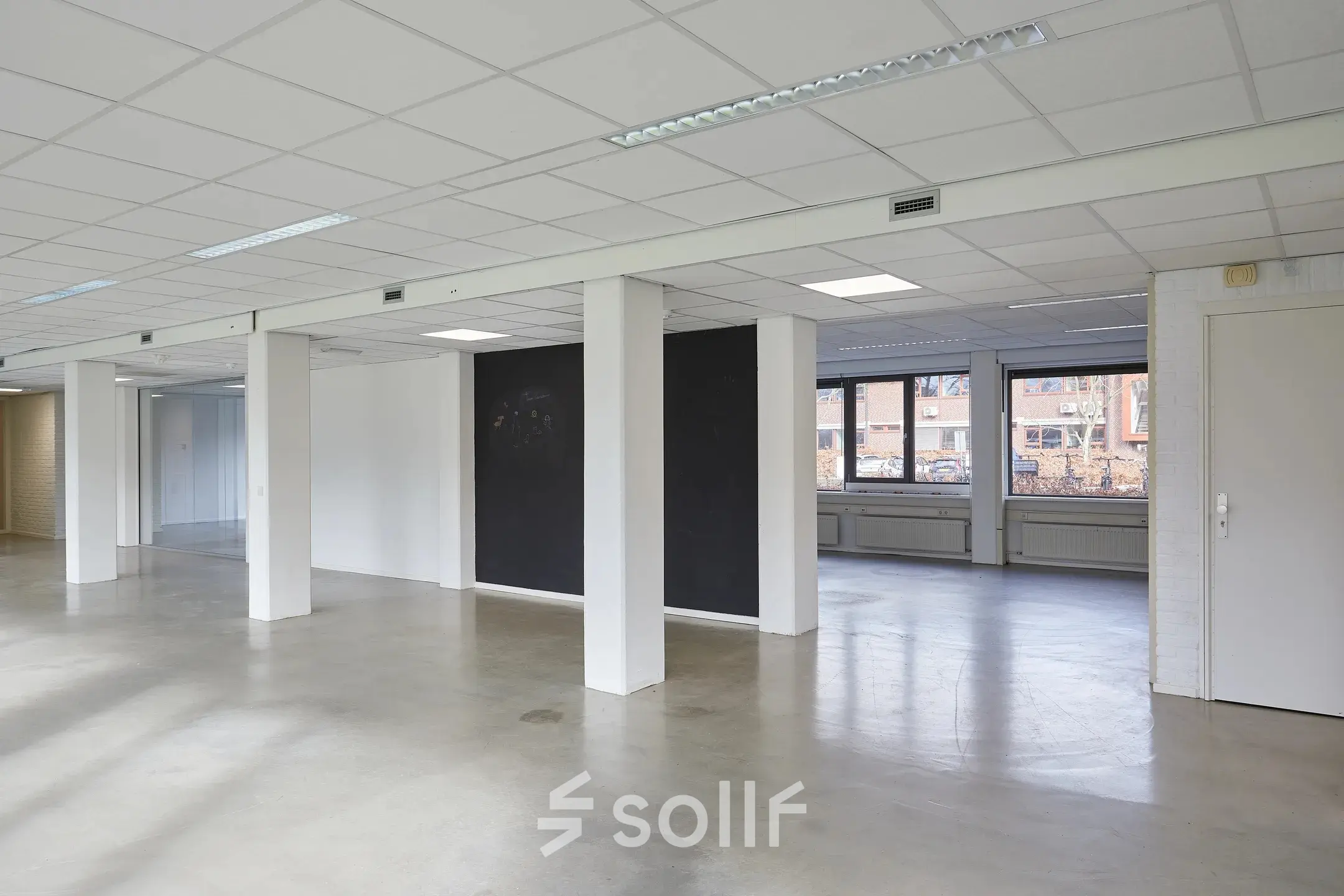 Spacious and unfurnished office space available for rent at Schweitzerlaan 12, Groningen. Features open floor plan with ample natural light, ideal for custom office space rental setup.