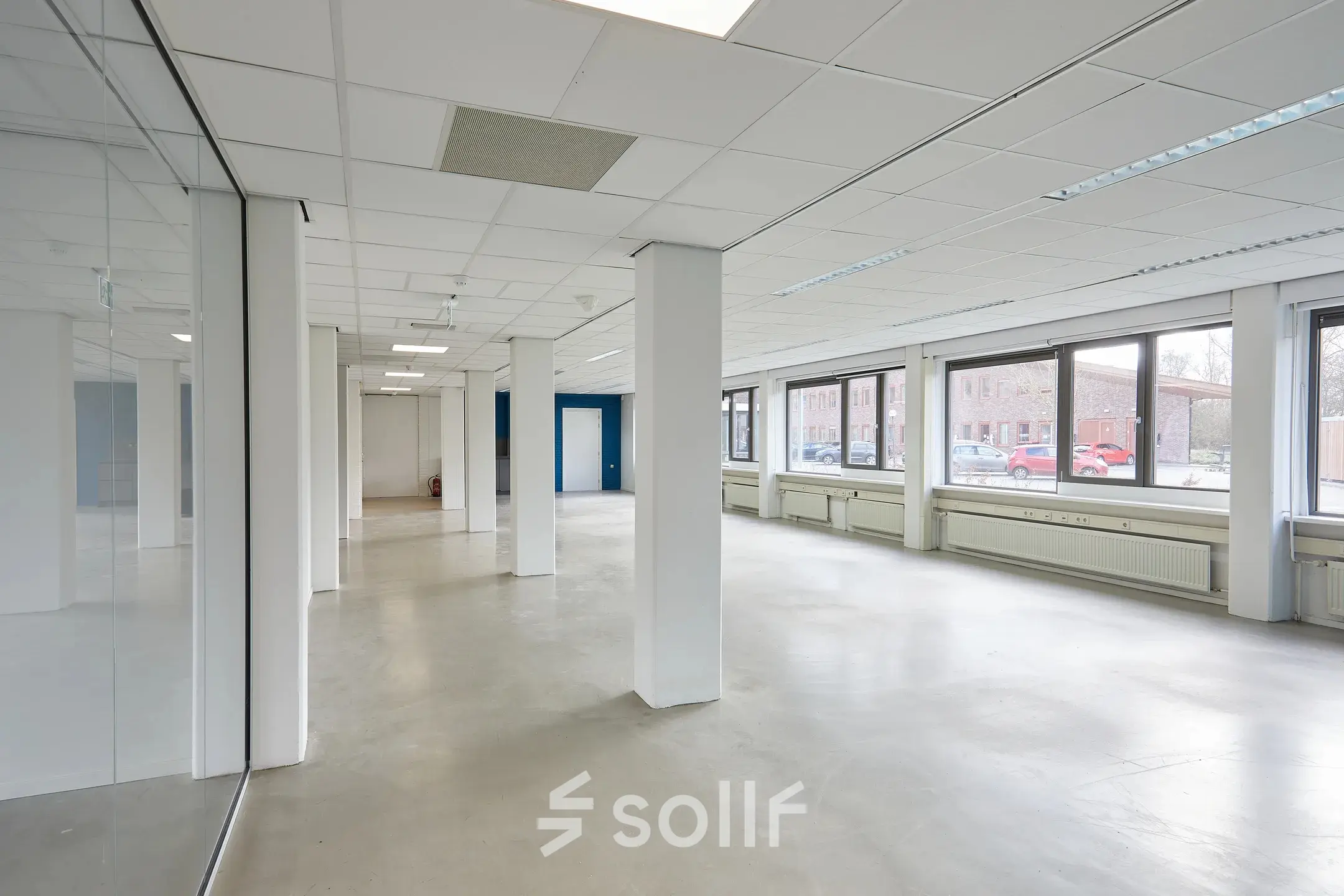 Spacious office space available for rent at Schweitzerlaan 12, Groningen, featuring large windows and an open floor plan for optimal workspace layout.