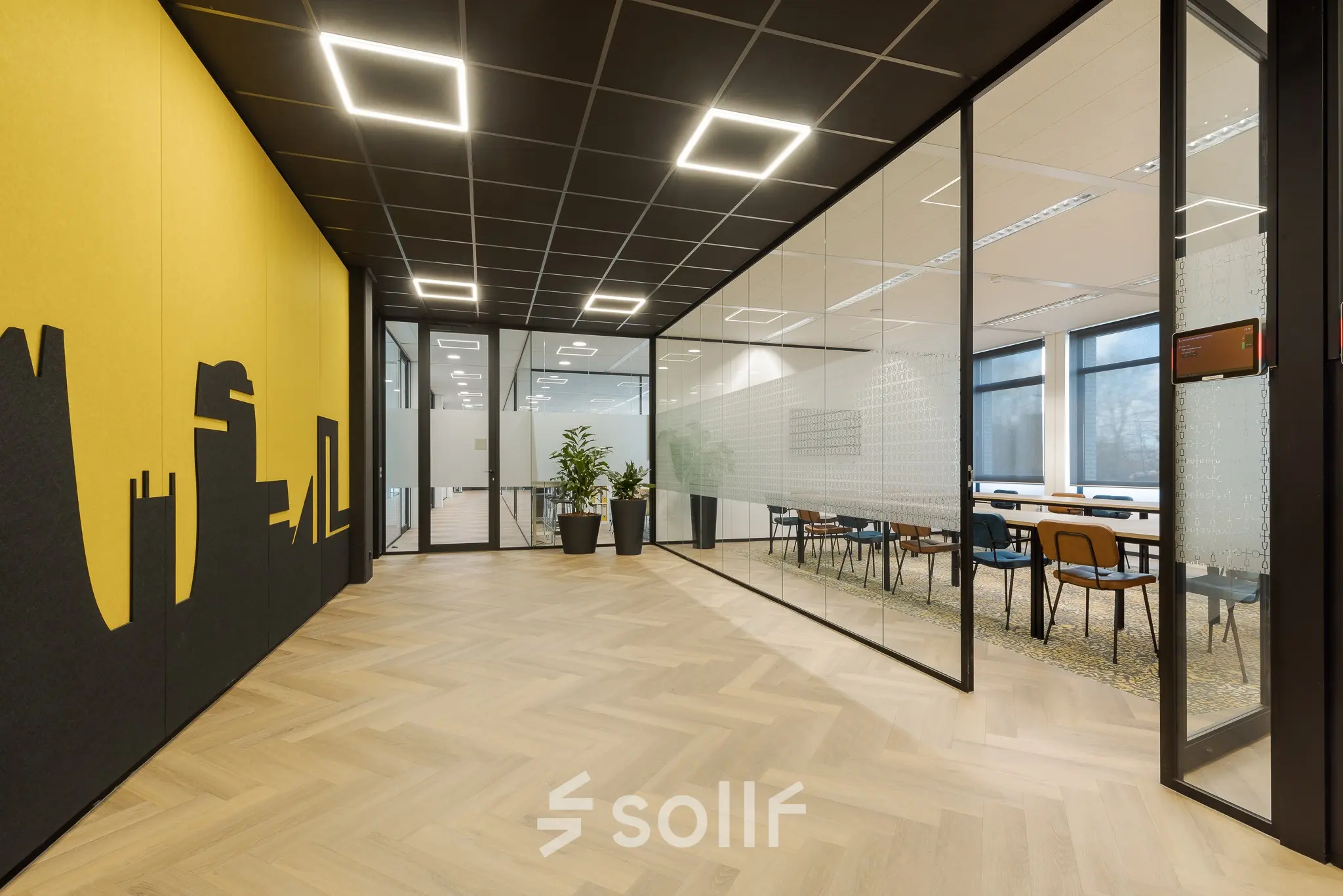 Modern office space at Zernikepark 12, Groningen featuring a glass-walled conference room for office space rental.