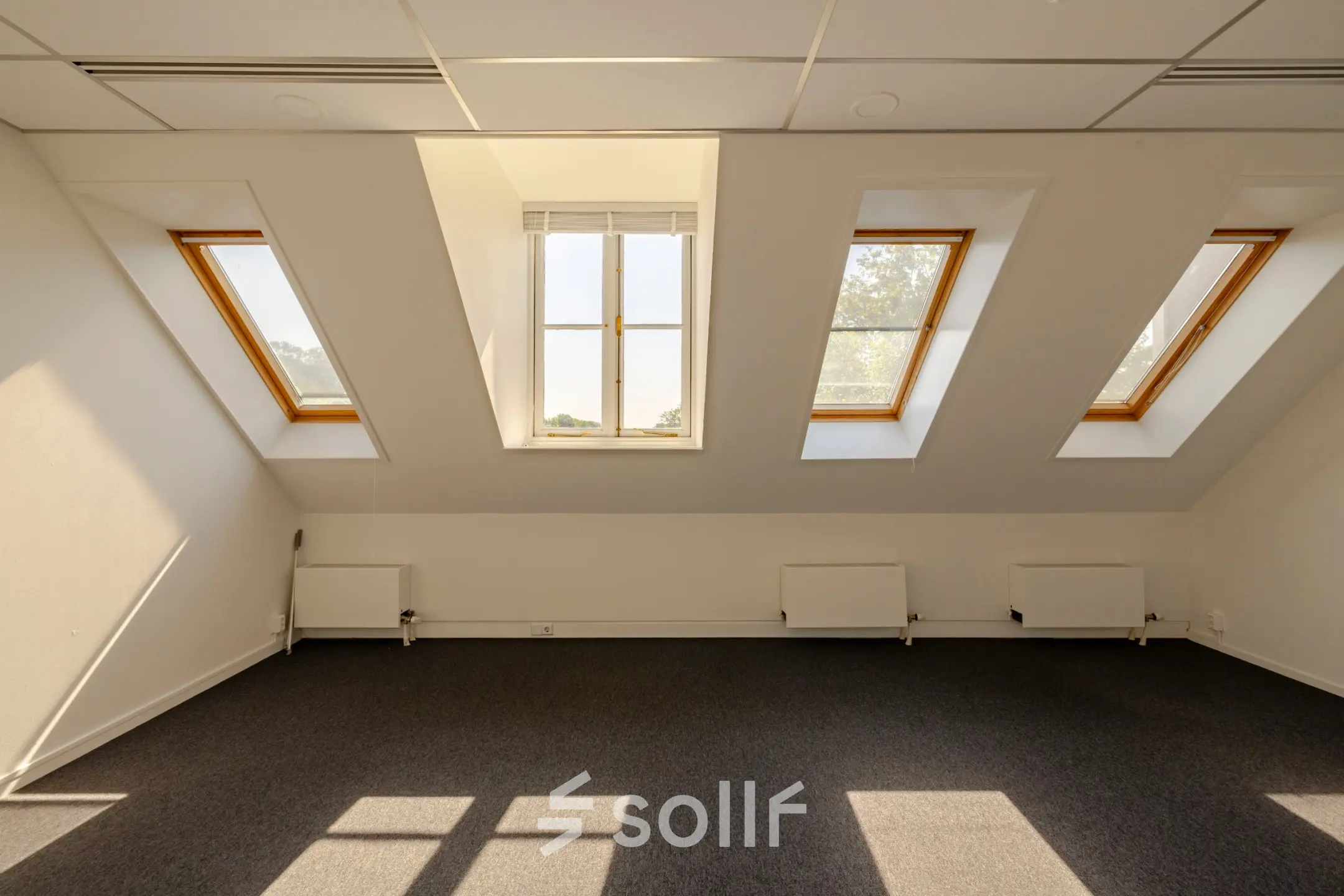 Bright office space at Kennemerplein 20 with skylight windows, offering natural light perfect for office space rental.