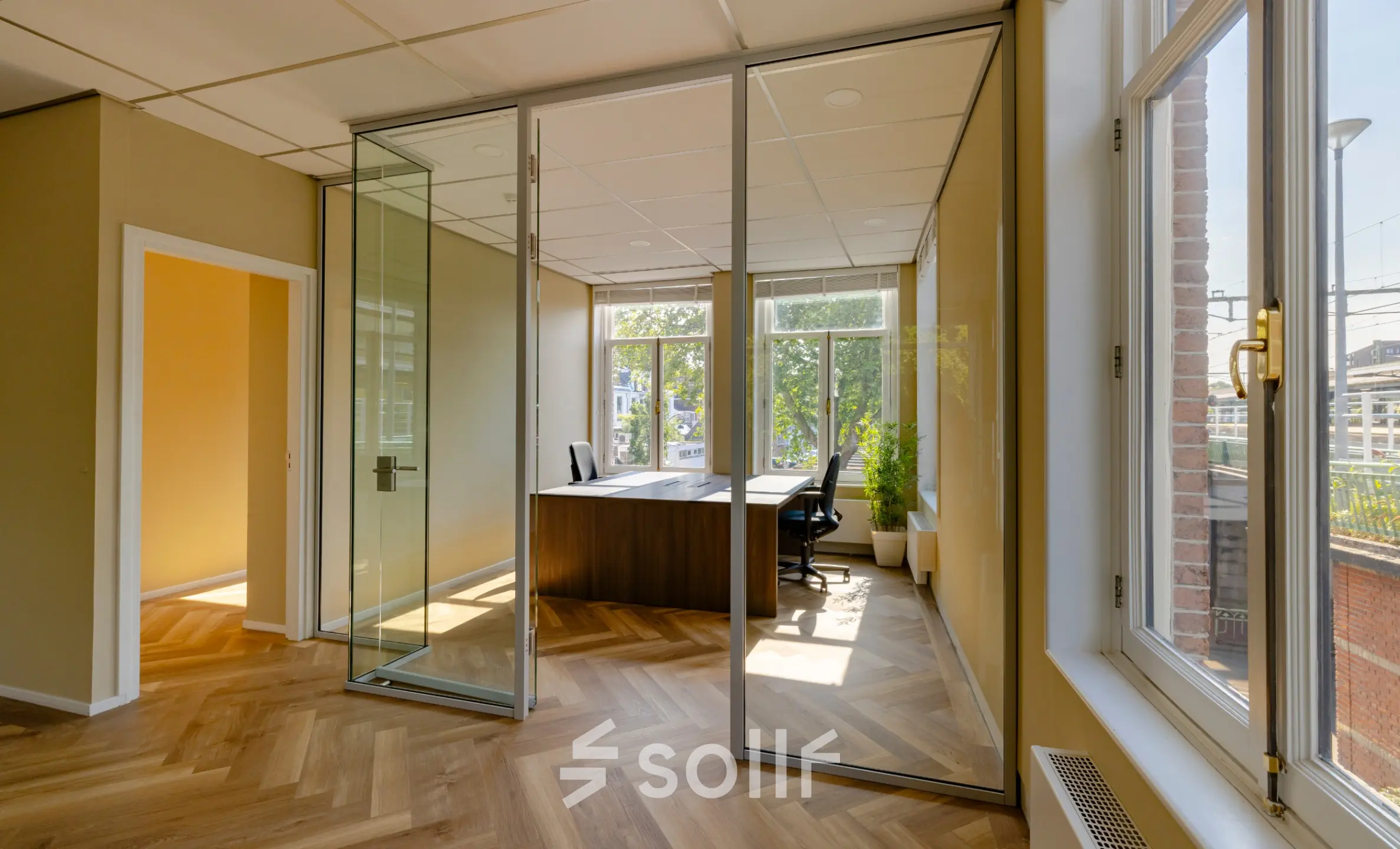 Bright, unfurnished office space with large windows and glass walls at Kennemerplein 20 in Haarlem Centraal Station, ideal for office space rental.