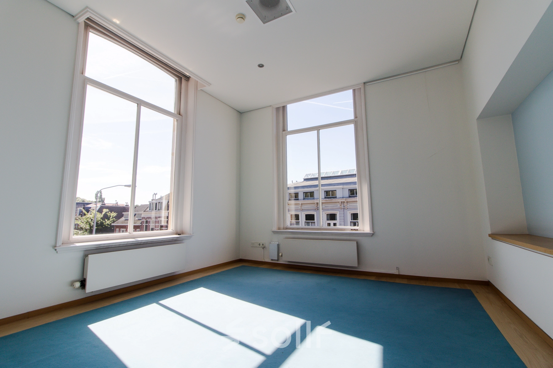 Bright, unfurnished office space with large windows for rent at Prinsen Bolwerk 1, near Haarlem Centraal Station.
