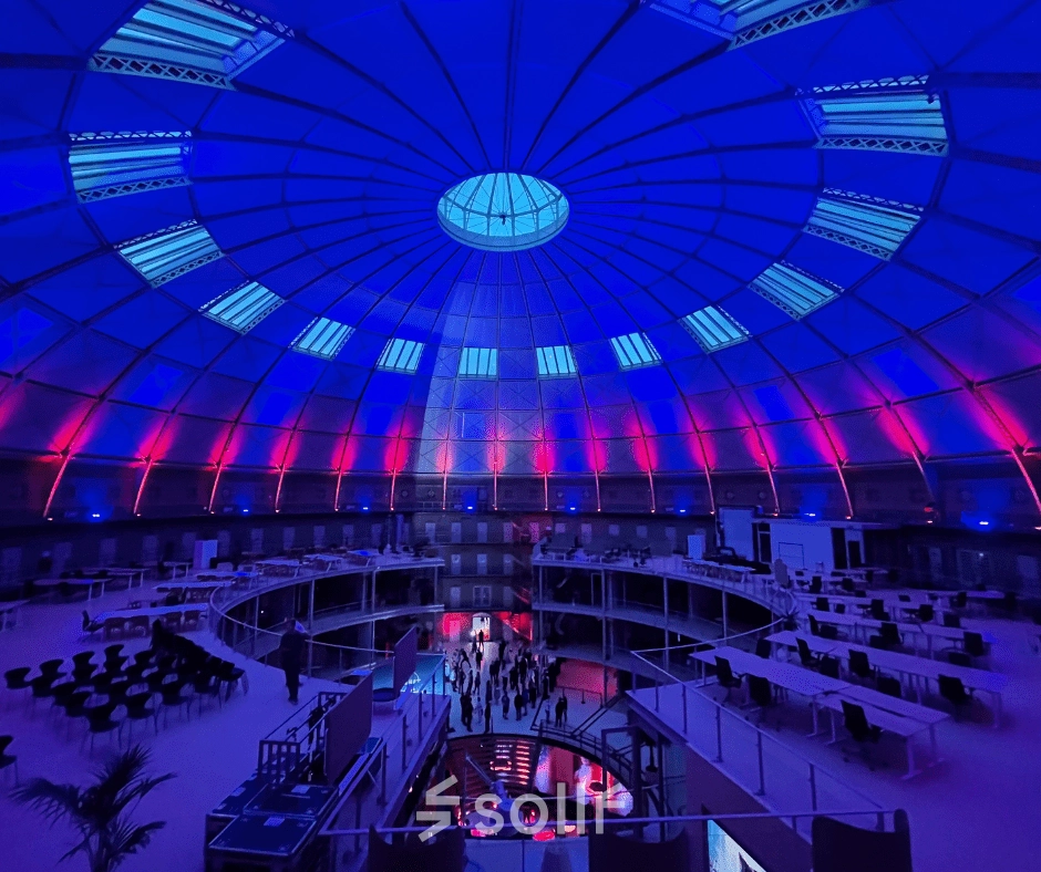 Spacious office space rental in Haarlem Centrum with a stunning dome ceiling and ambient lighting, perfect for an open floorplan setup.