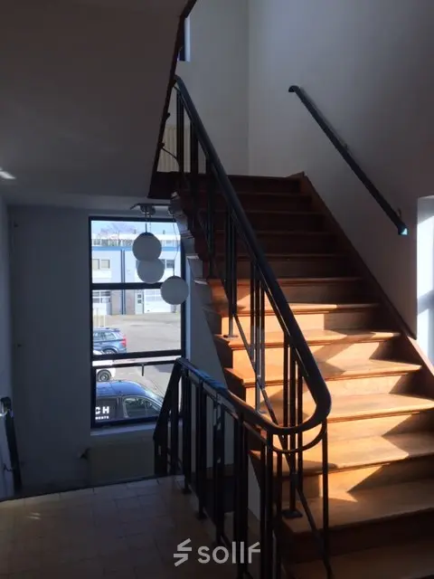 Interior view of a staircase with wooden steps and railings, located at Nijverheidsweg 50 in Haarlem Oost, nearby office space rental options.