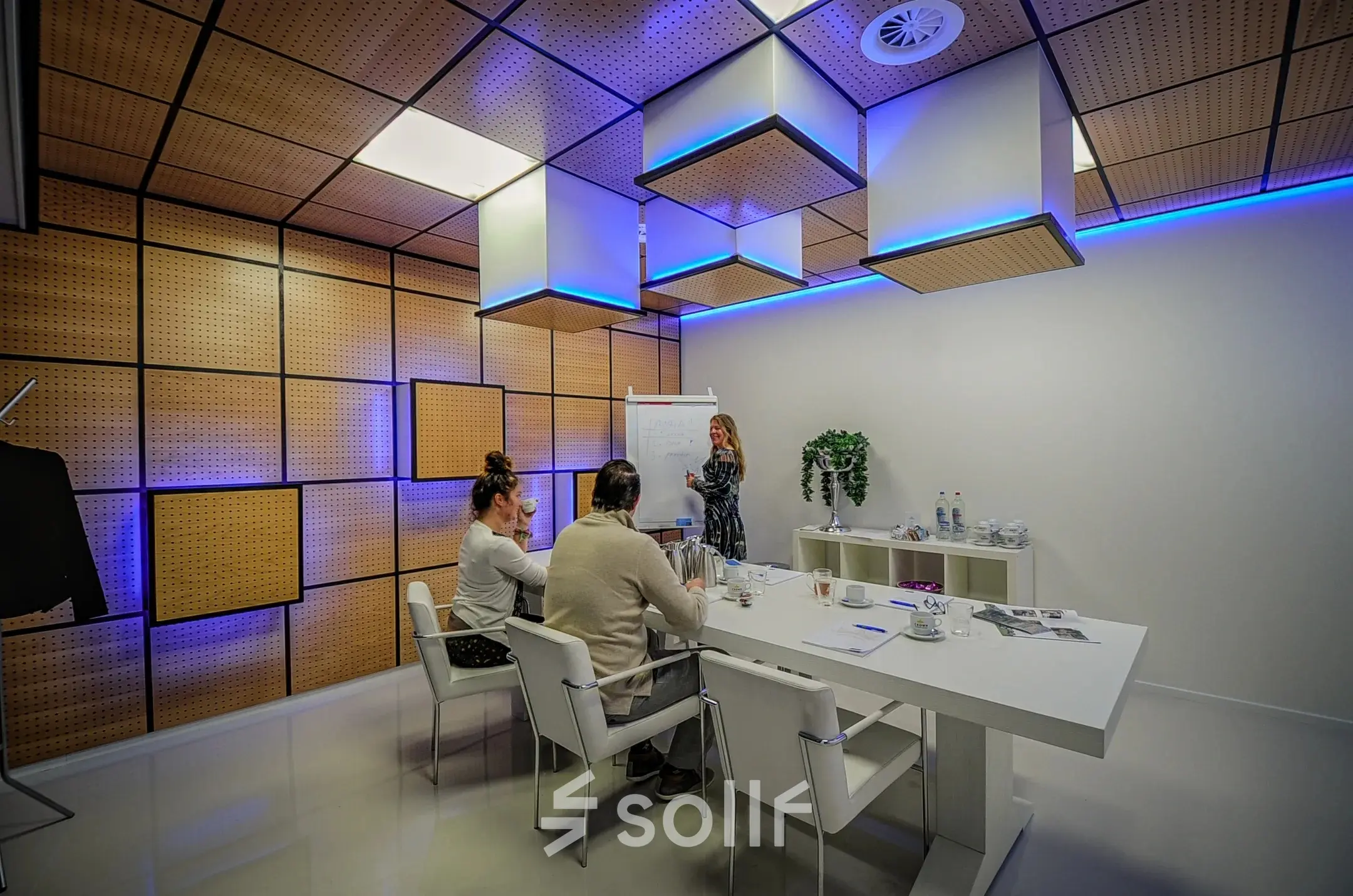 A modern conference room at A. Hofmanweg 5A in Haarlem Waarderpolder, featuring people engaged in a meeting. Ideal office space rental for dynamic teams.