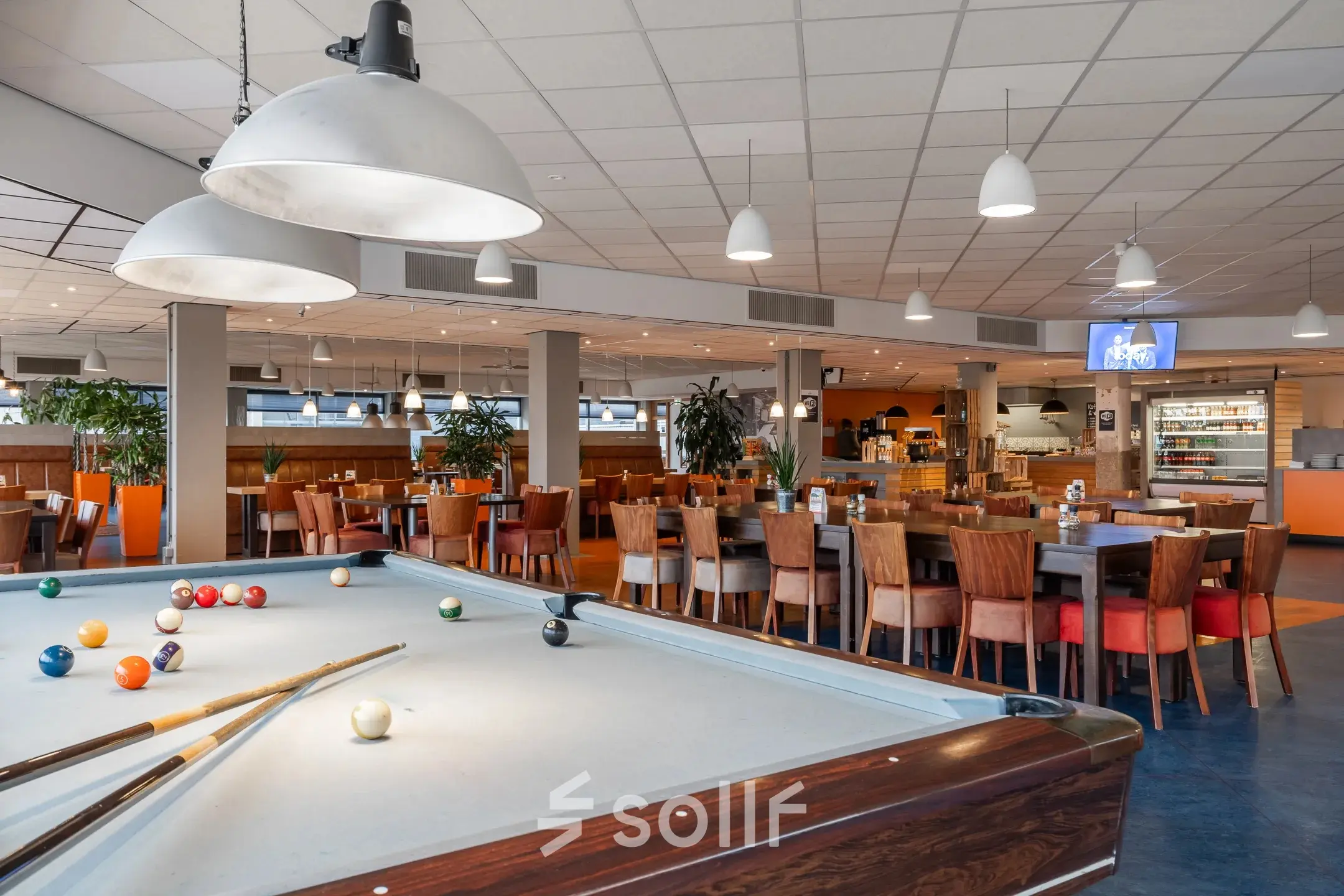 Spacious, vibrant office space available for rent at A. Hofmanweg 5A in Haarlem Waarderpolder, featuring a pool table and dining area.