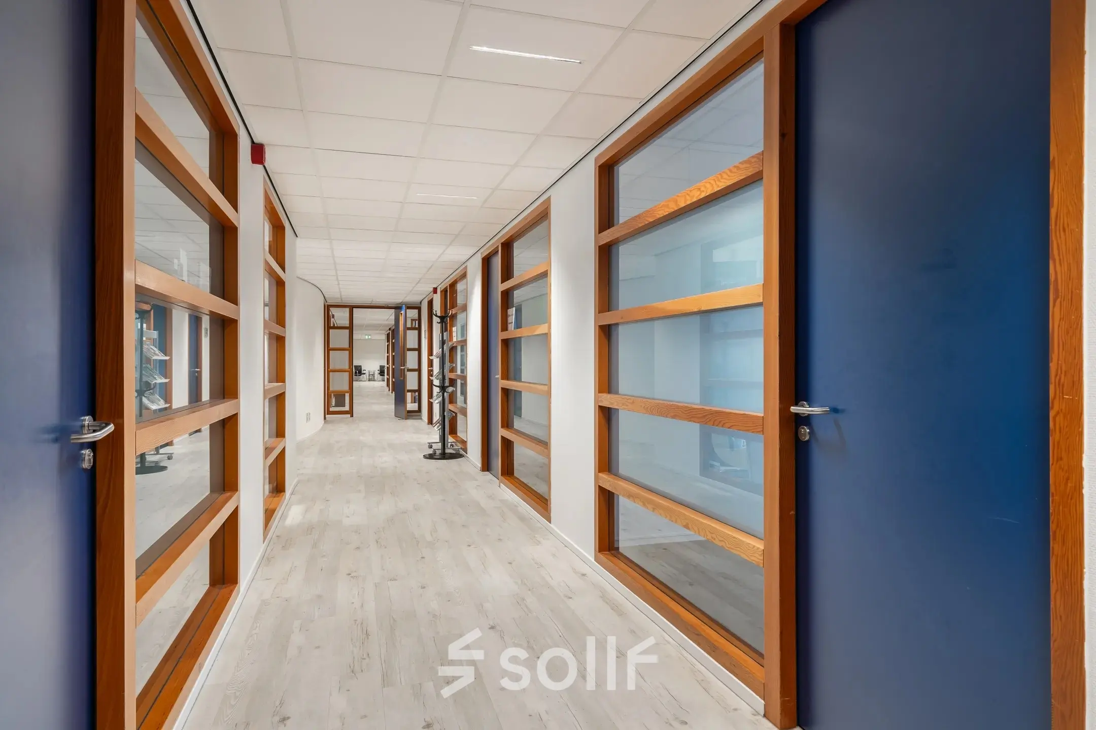 Bright hallway at A. Hofmanweg 5A in Haarlem Waarderpolder, showcasing modern office space rental options with wooden and glass doors.